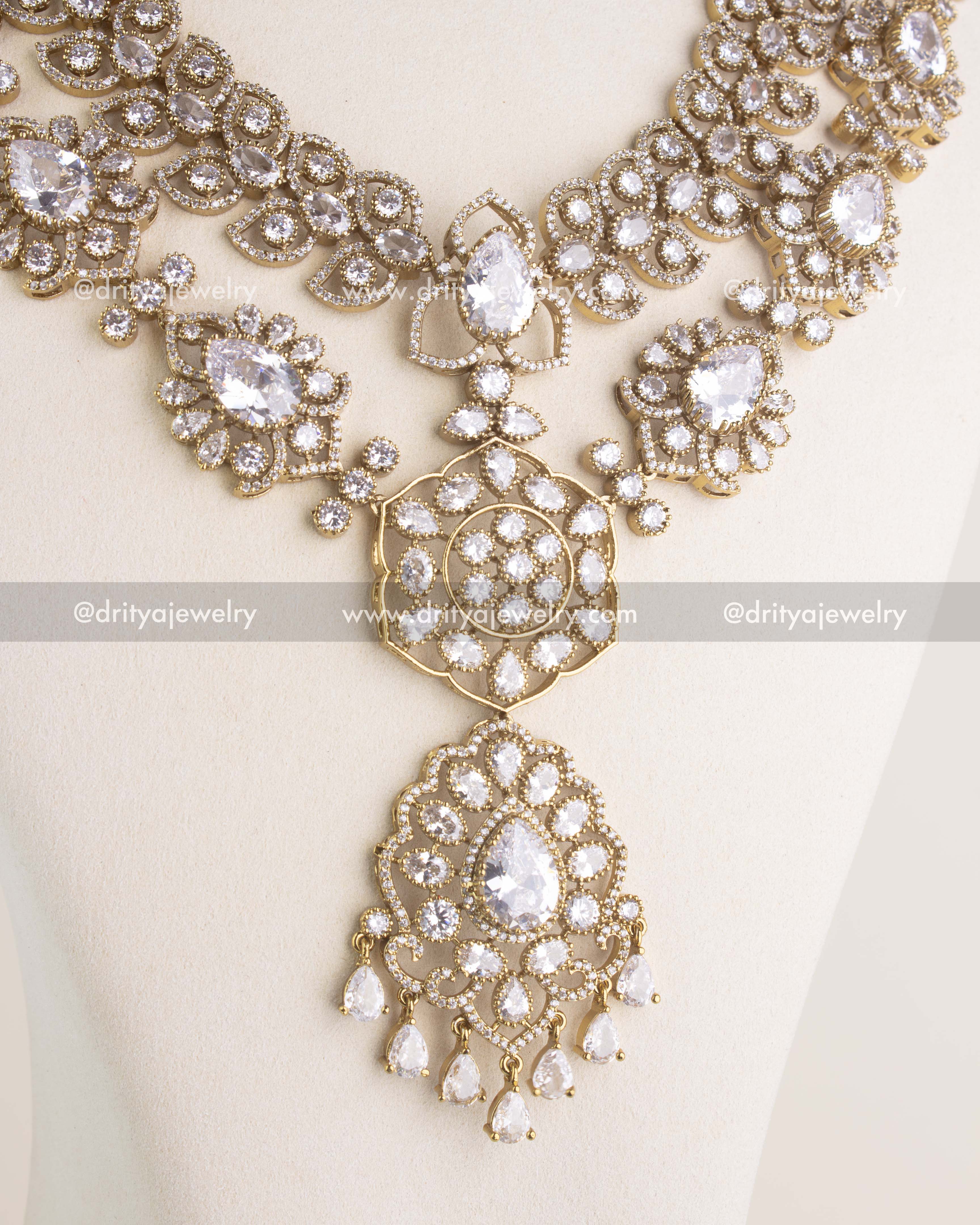 Layered Victorian long necklace with clear CZ stones and central pendant on display bust