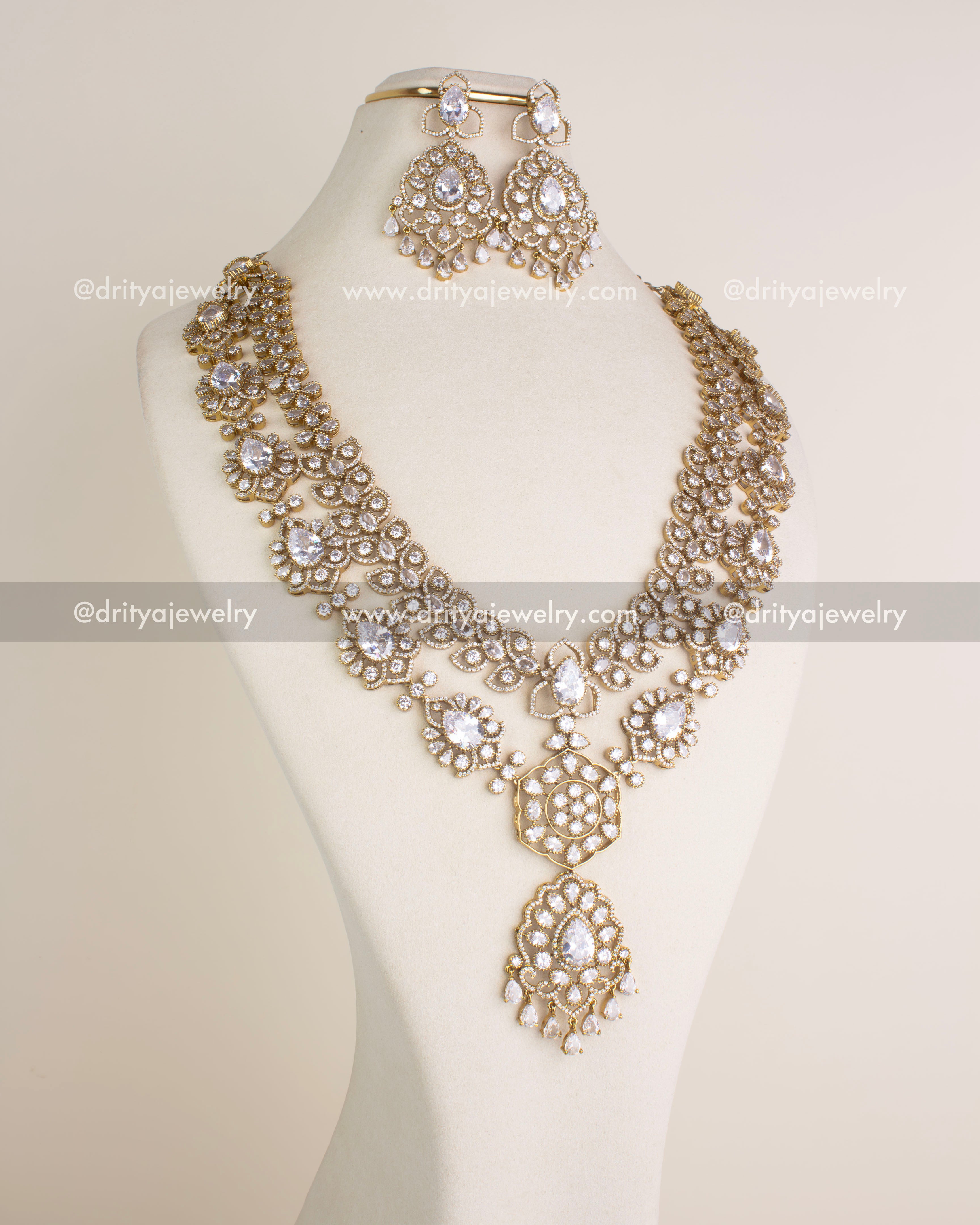 Full necklace set with long layered necklace and earrings styled on bust stand