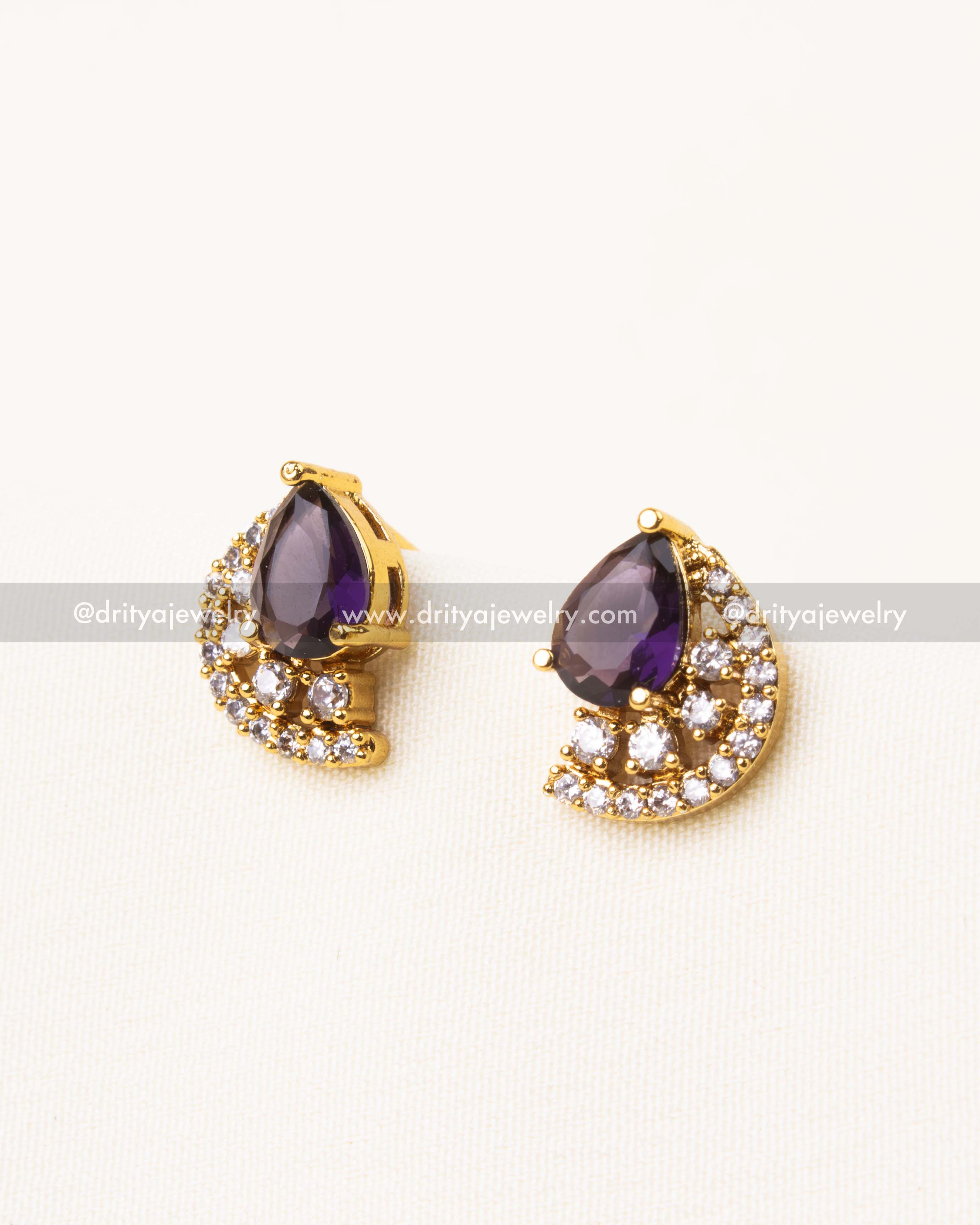 Purple pear-shaped CZ stud earrings encircled with diamond-alike halo.