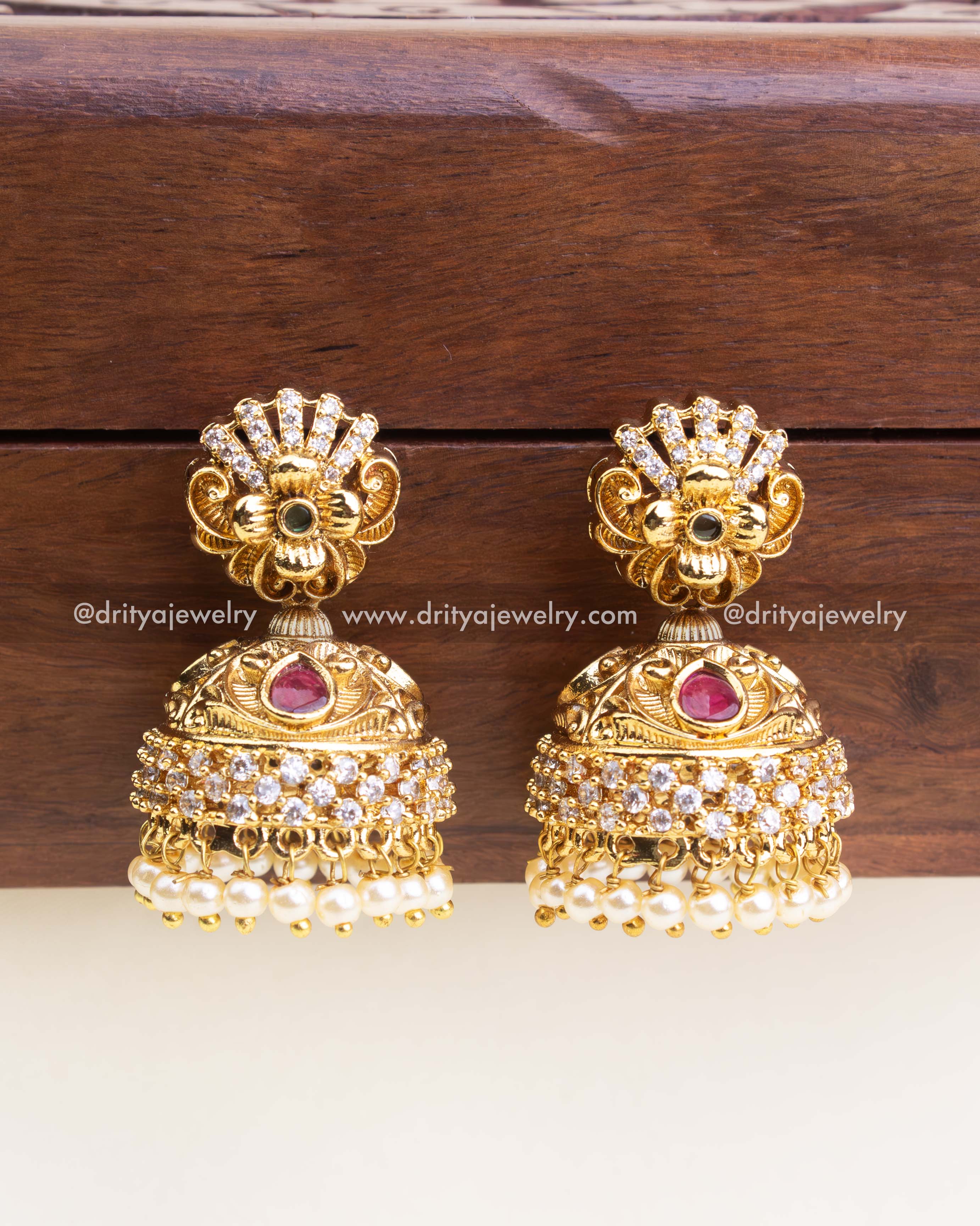 Traditional antique jhumka earrings with CZ stones, ruby accents, and pearl danglers - no deity design.