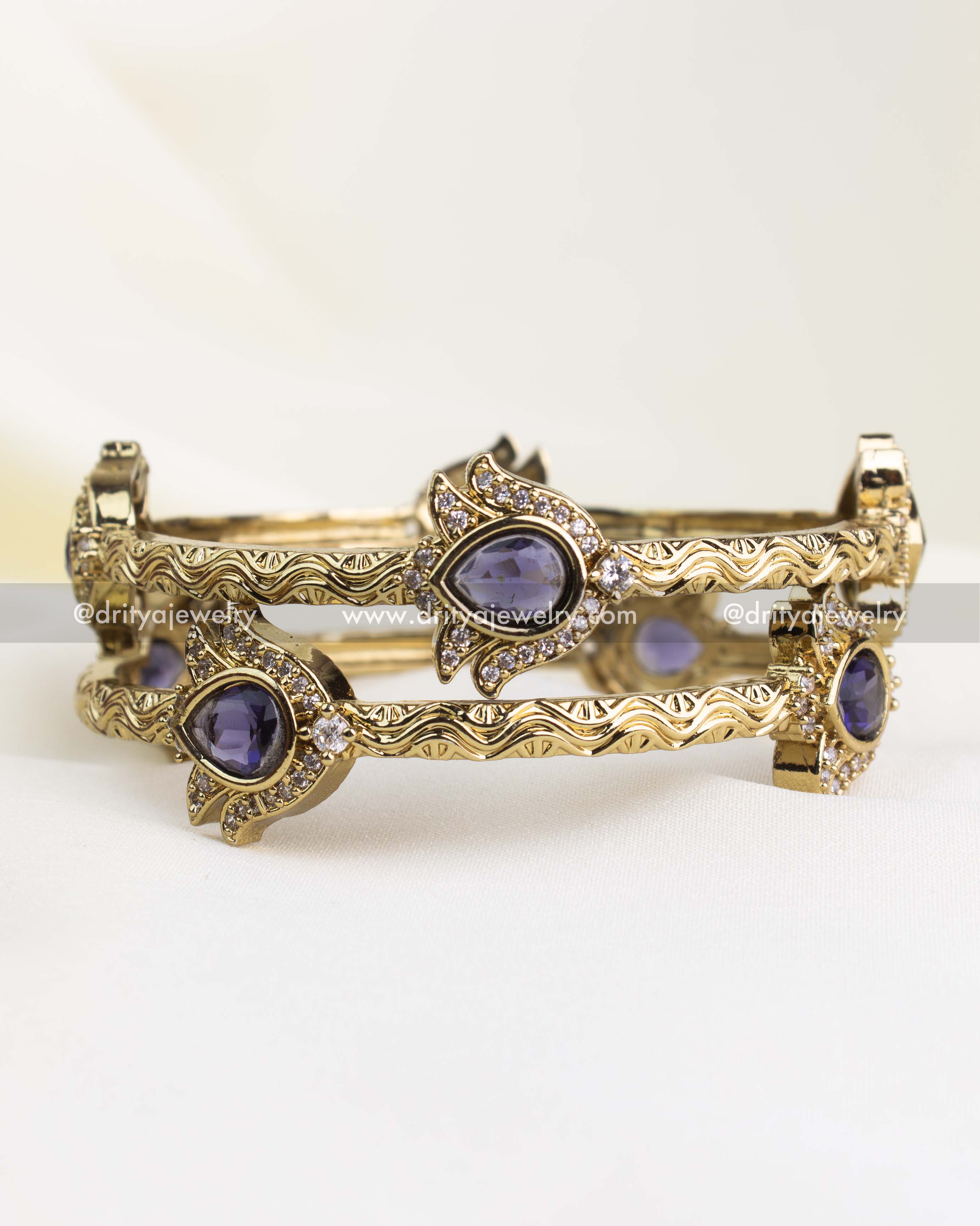 Antique gold finish kada with purple pear-cut stones and CZ border detailing.