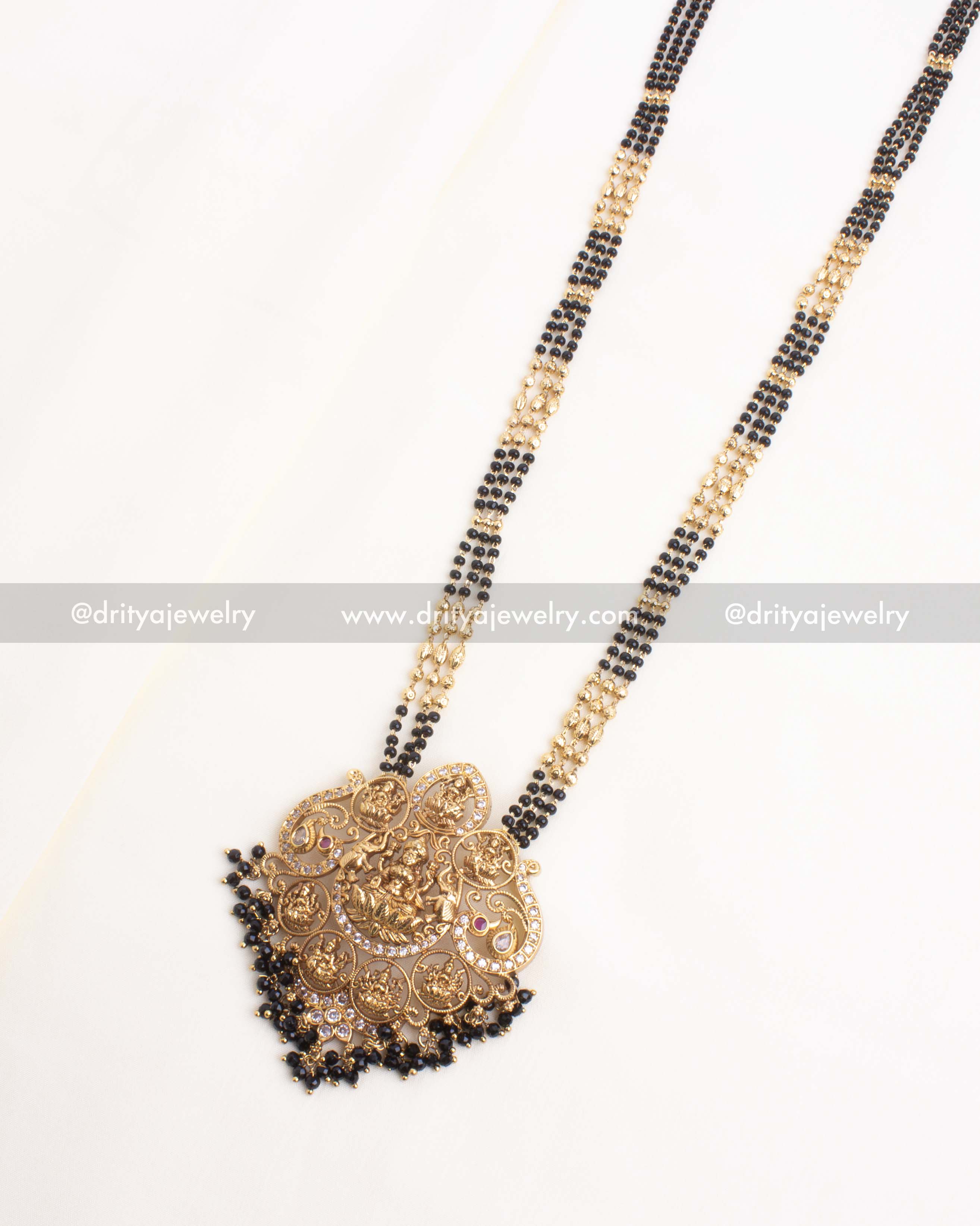 Traditional Ashta Lakshmi necklace with black beads and a grand antique gold medallion.