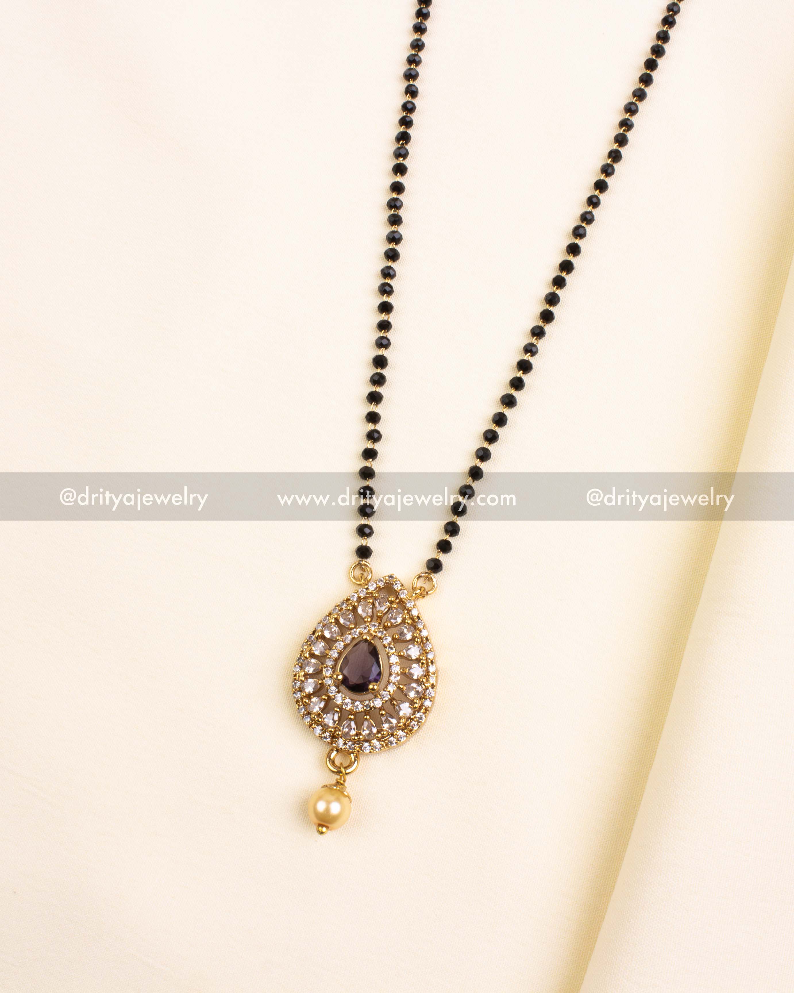 Purple teardrop pendant on black bead chain with pearl drop and crystal halo.