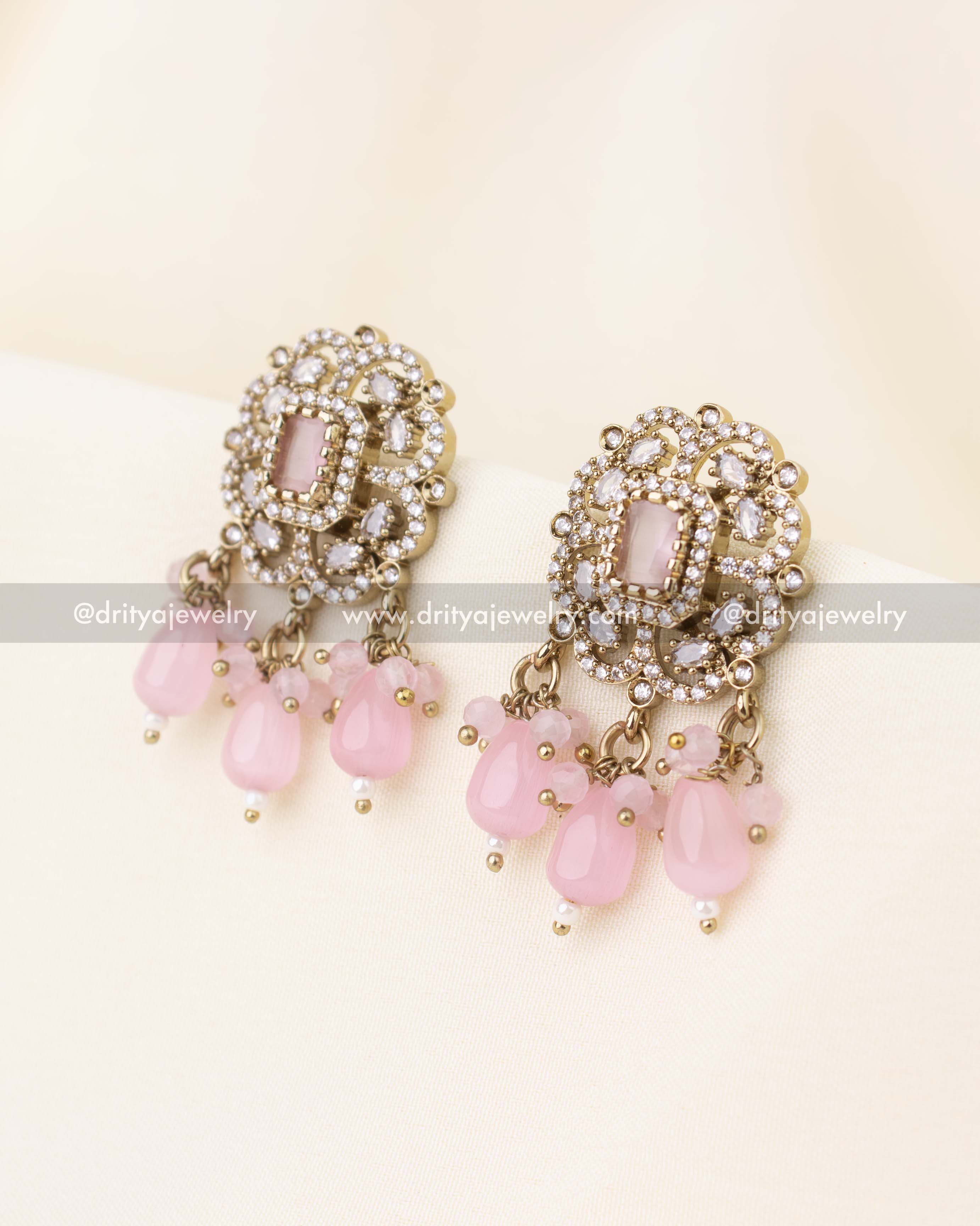 Matching blush pink Victorian stud earrings with dangling bead drops.