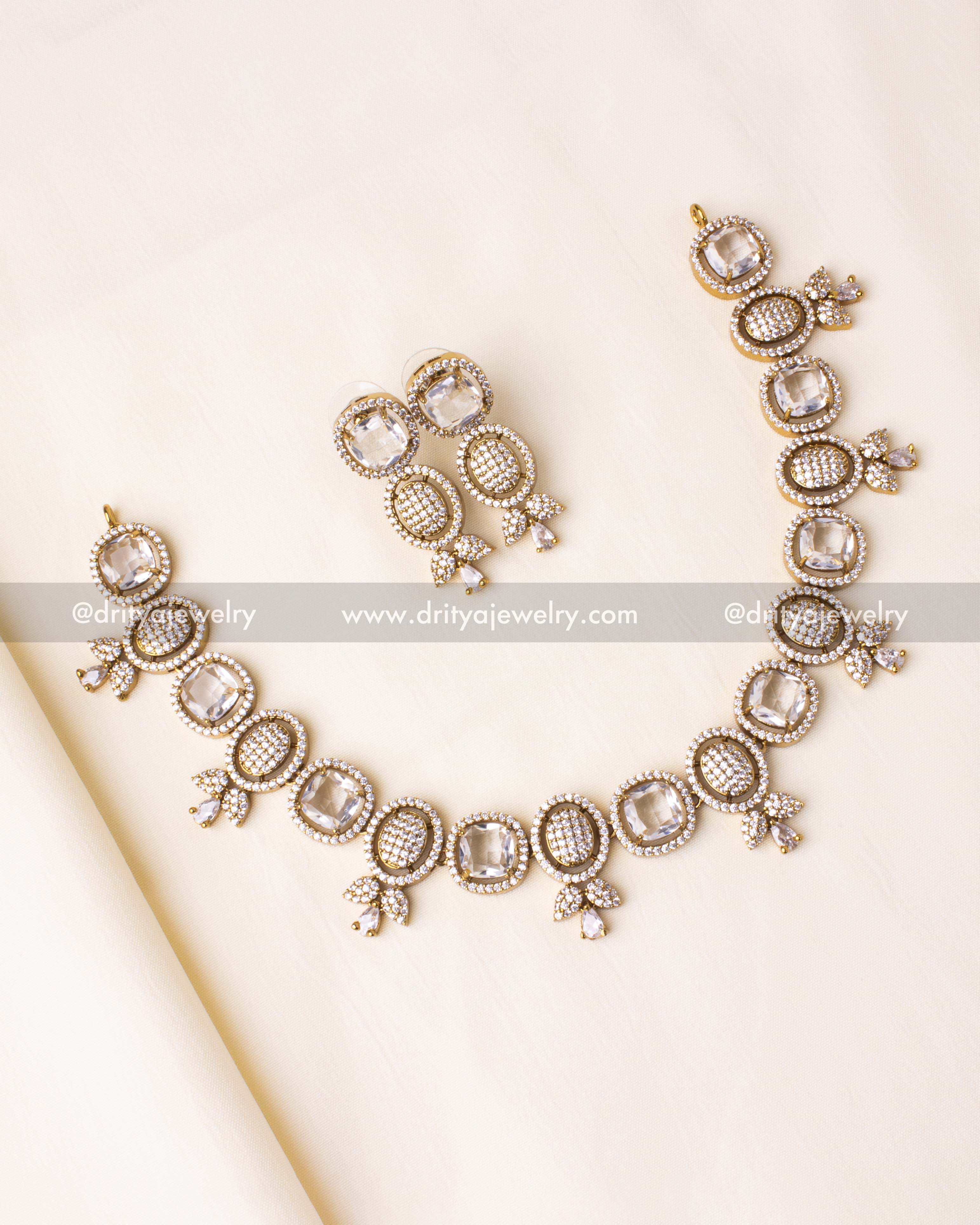 Elegant short necklace set featuring sparkling CZ stones in a gold-plated frame.