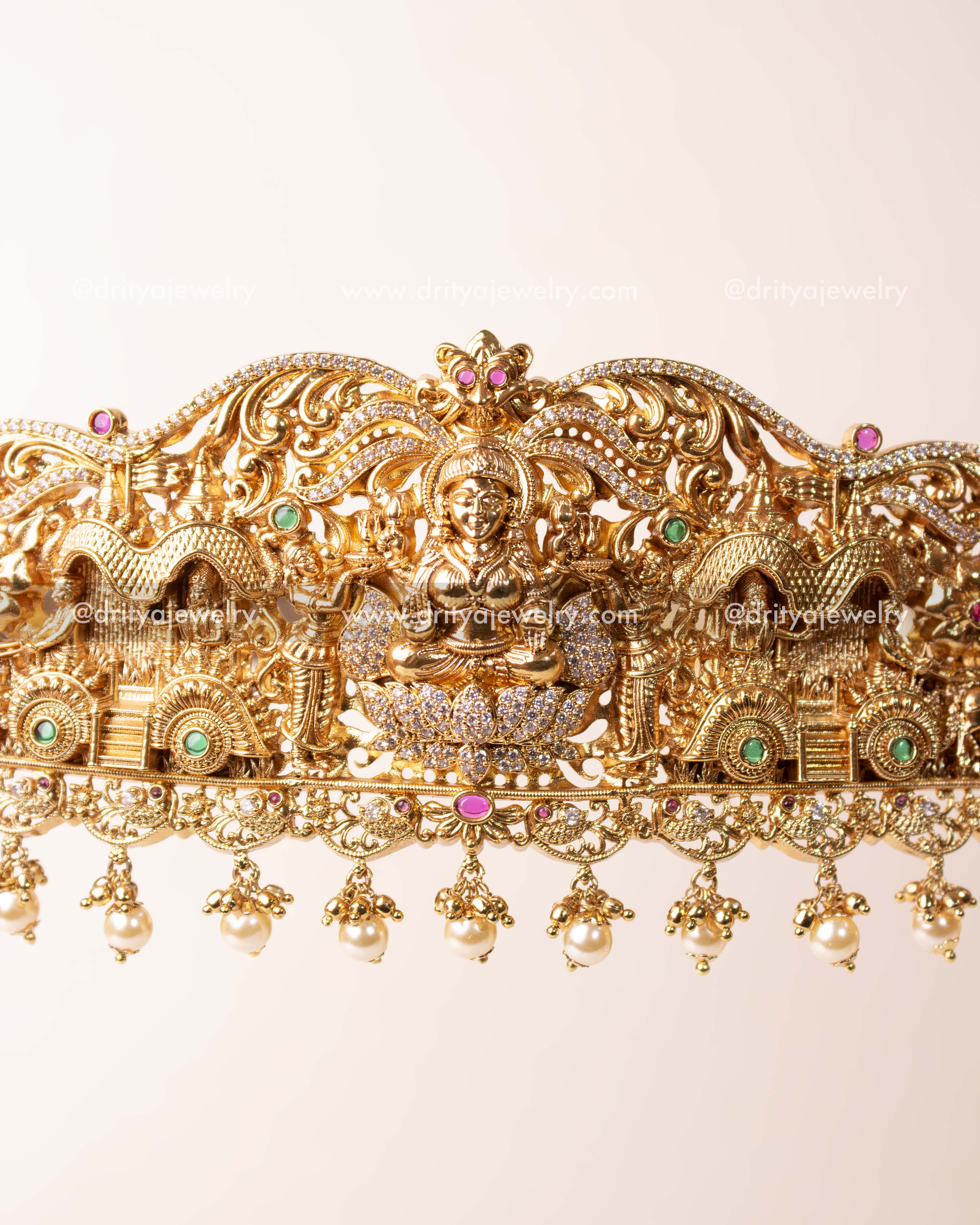 Close-up view of Goddess Lakshmi seated on a lotus, adorned with kundan stones and gold finish.