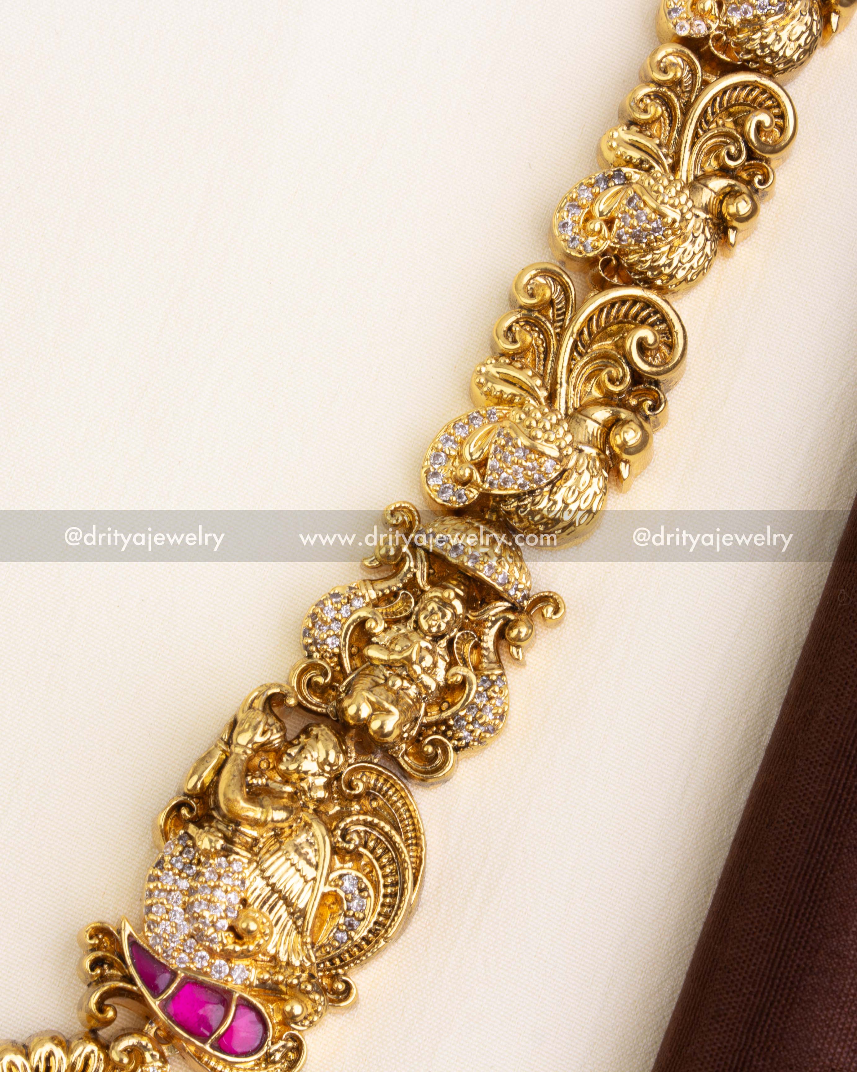 Intricately designed chain with peacock, goddess, and floral Nakshi carvings.