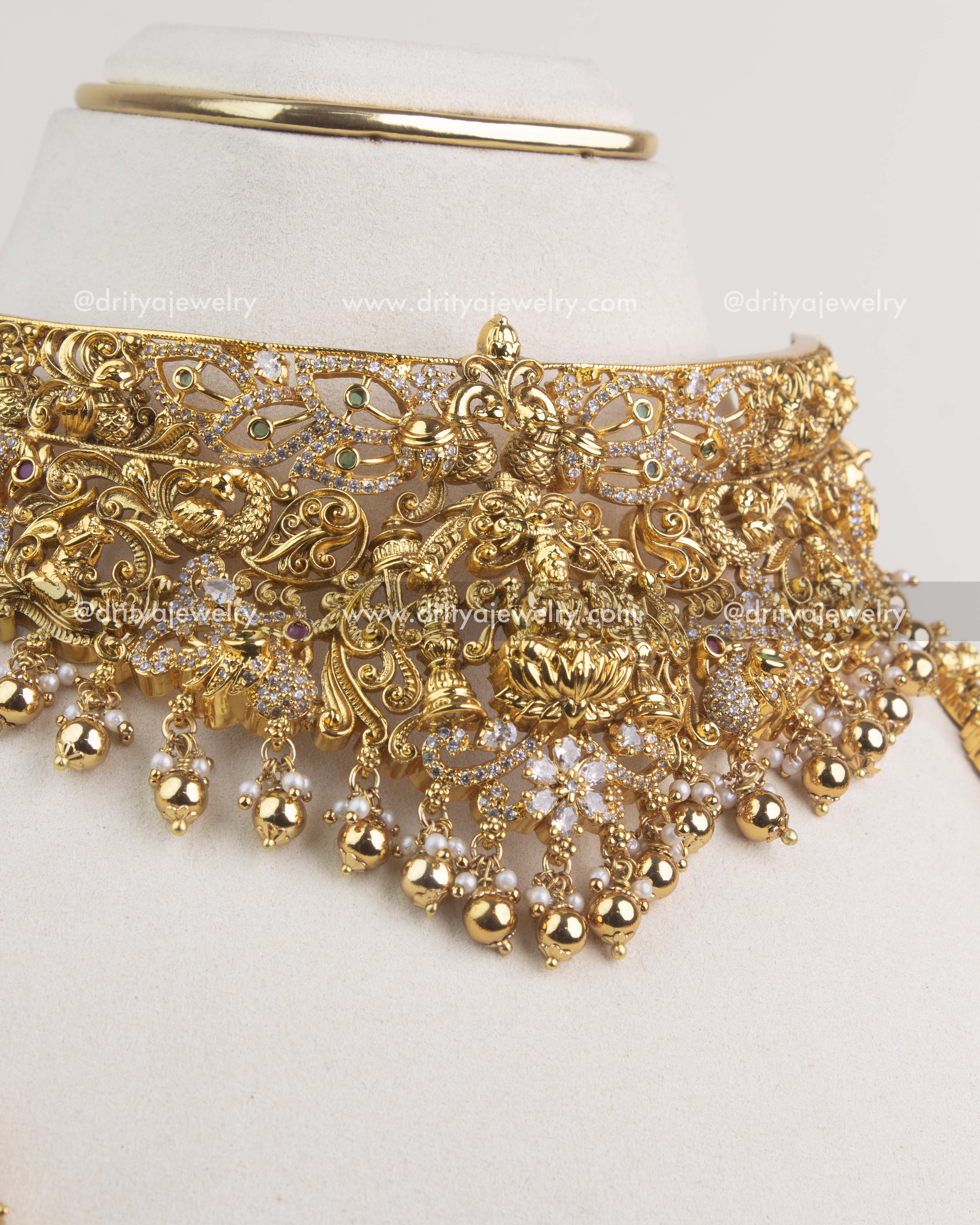 Antique gold temple choker with Lakshmi design, floral patterns, and pearl bead drops.