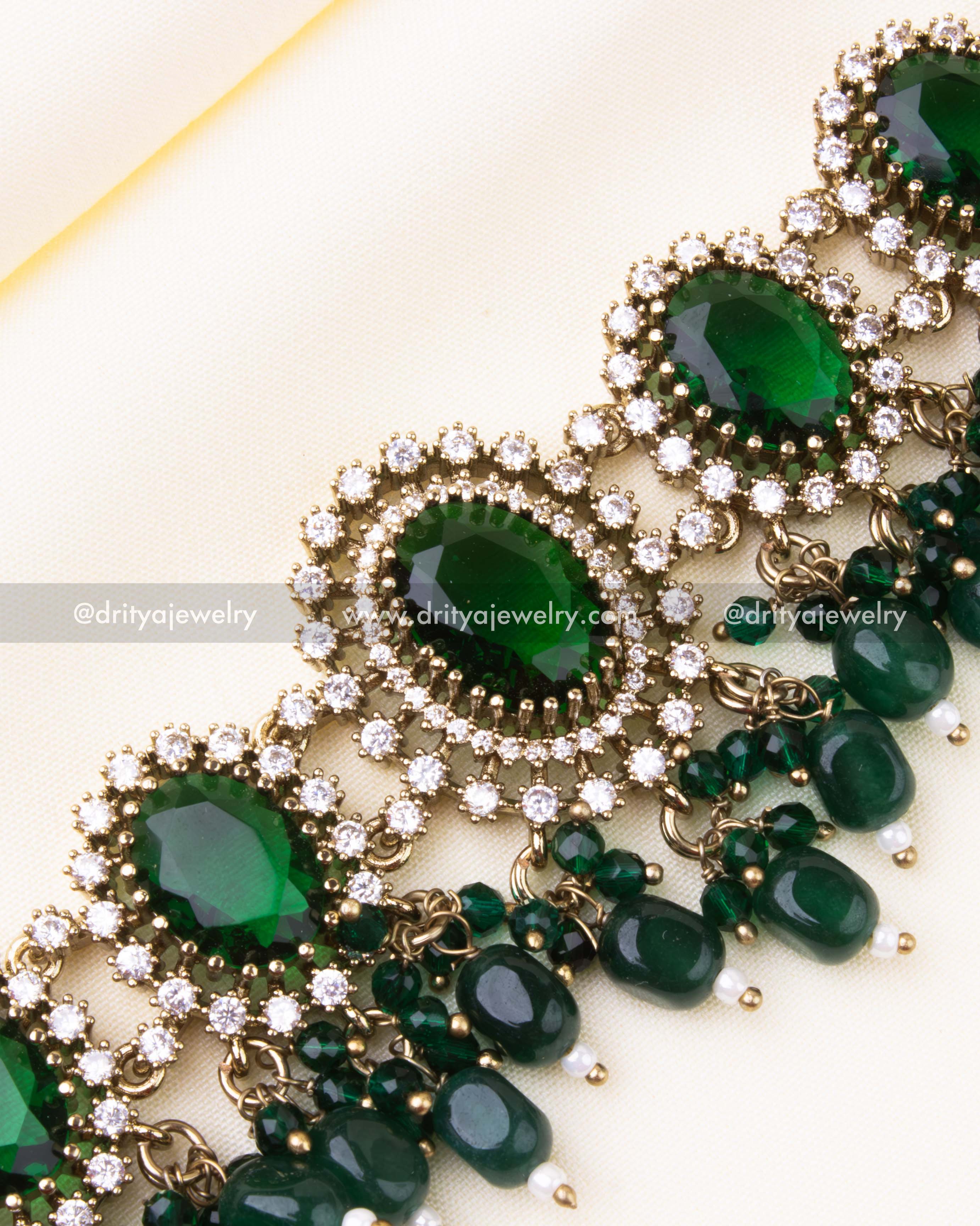 Detailed close-up of emerald green choker with drop beads and white stones