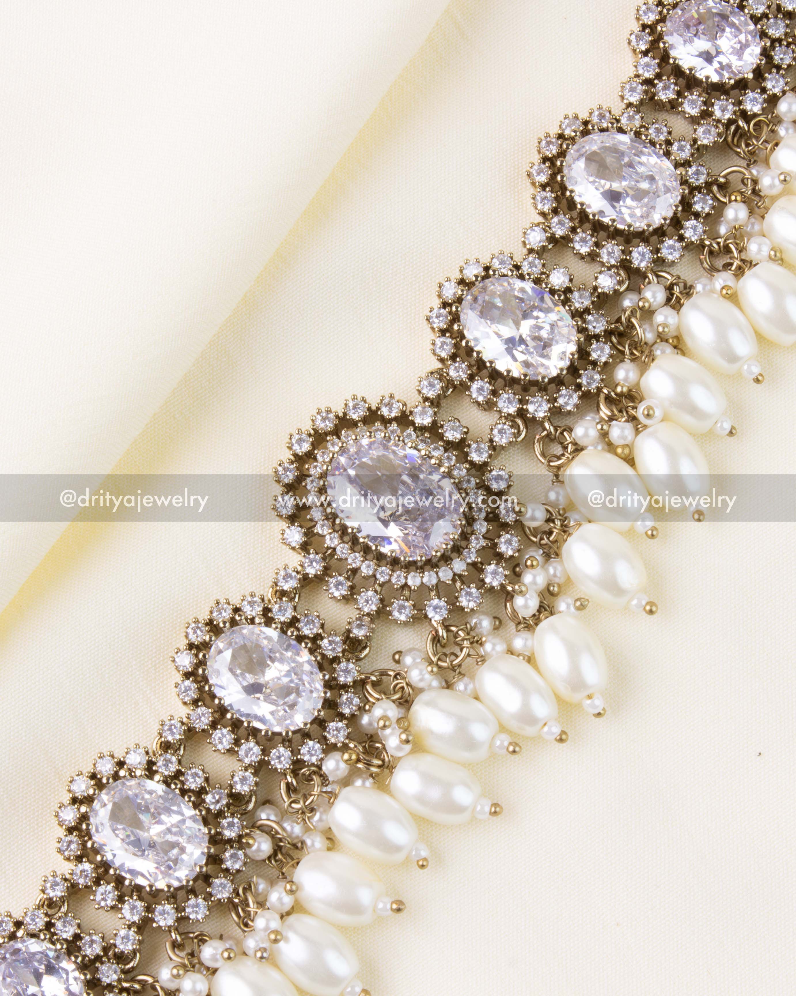 White center stones with halo setting and pearl fringe