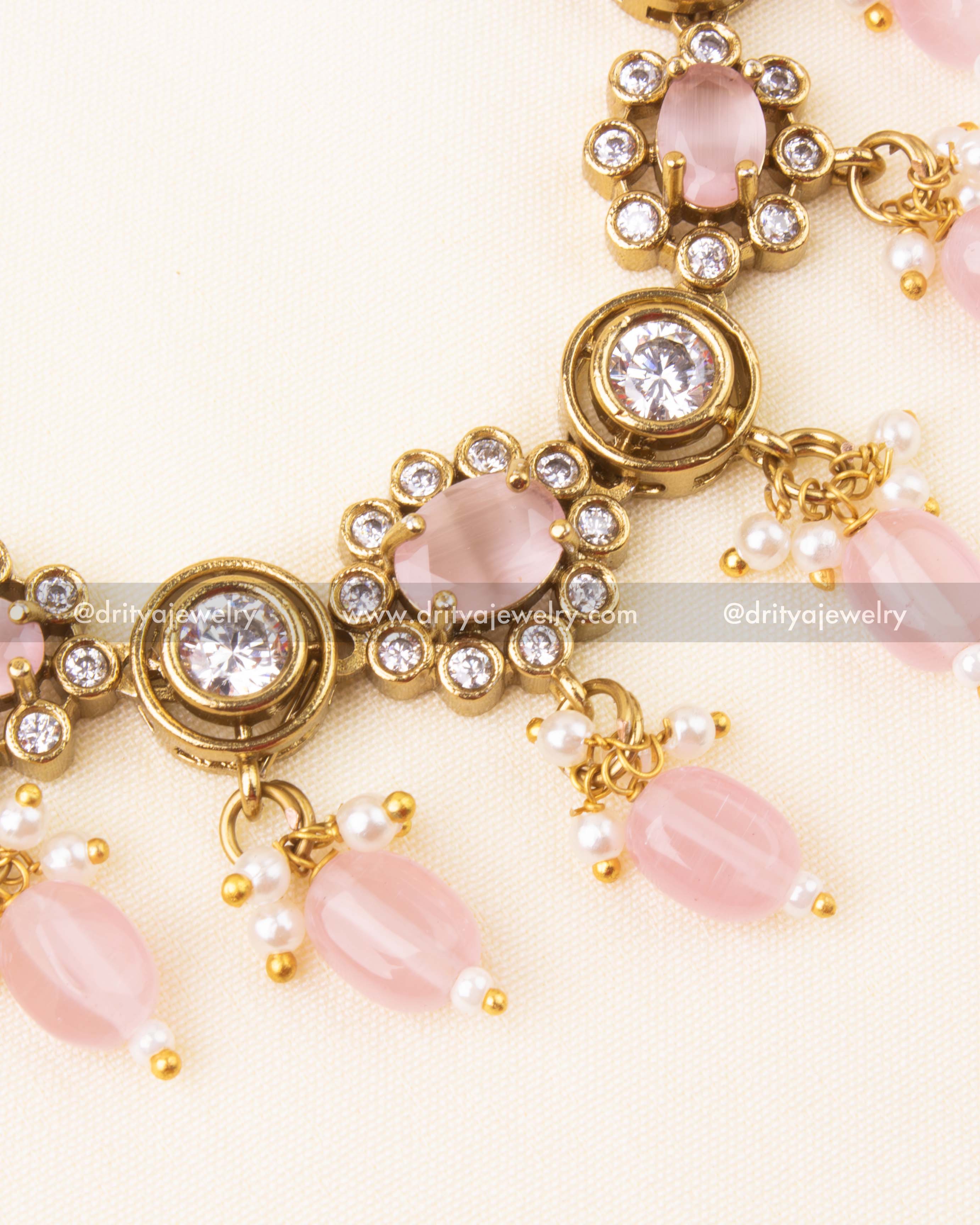 Detailed view of blush pink beads, AD floral accents, and Victorian setting.