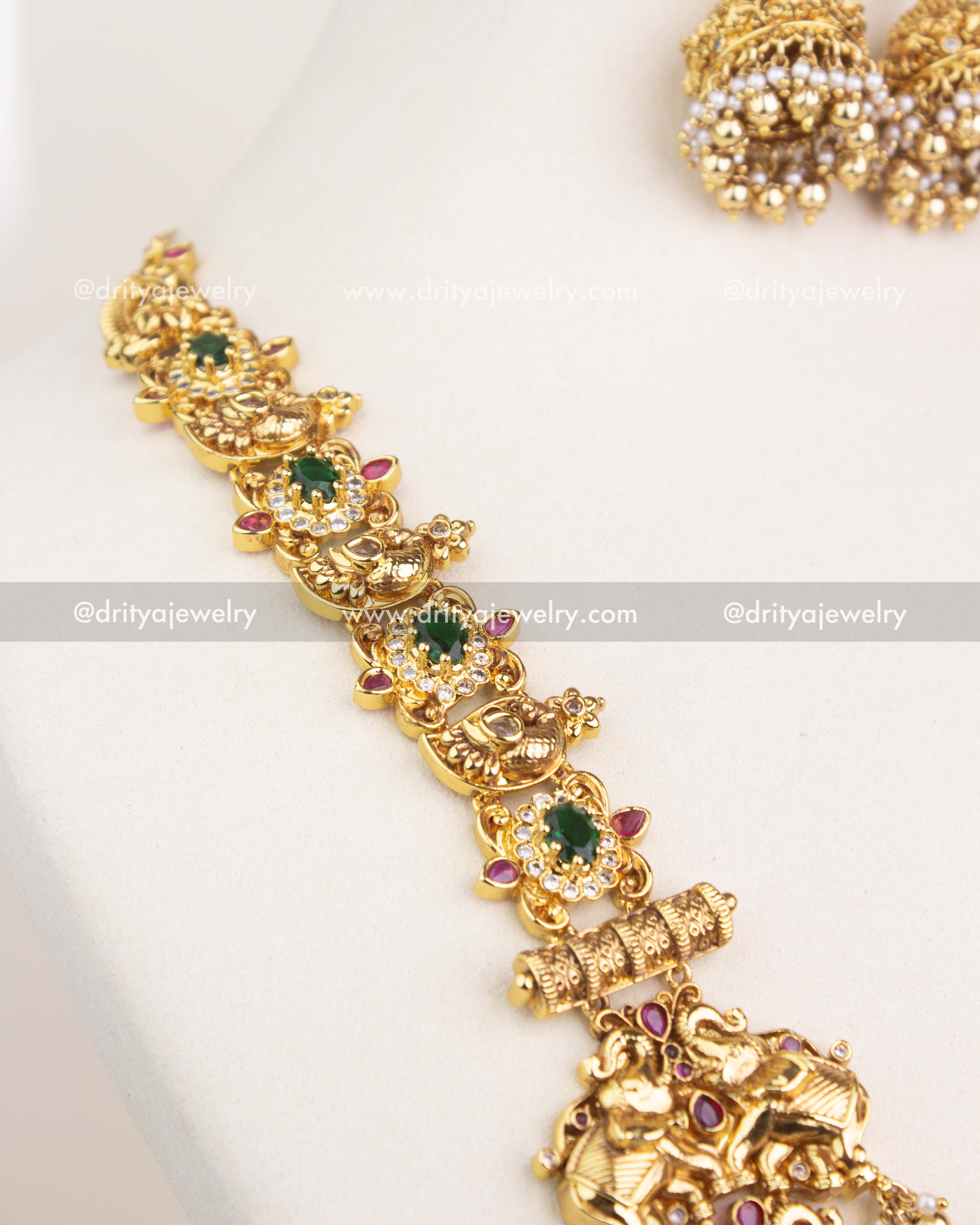 Detailed pendant design featuring Lakshmi, animal motifs, and CZ stone embellishments in antique polish.