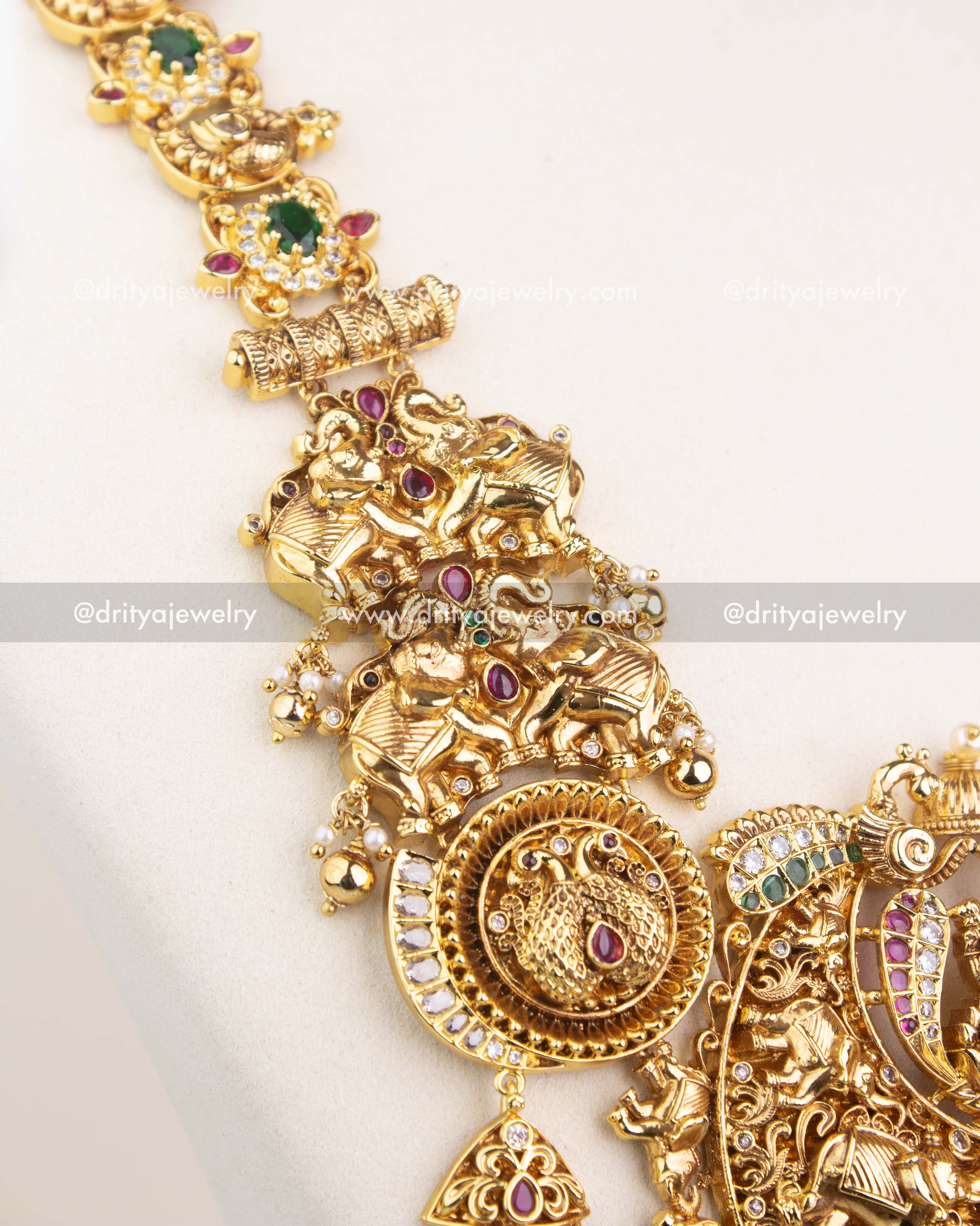 Detailed pendant design featuring Lakshmi, animal motifs, and CZ stone embellishments in antique polish.