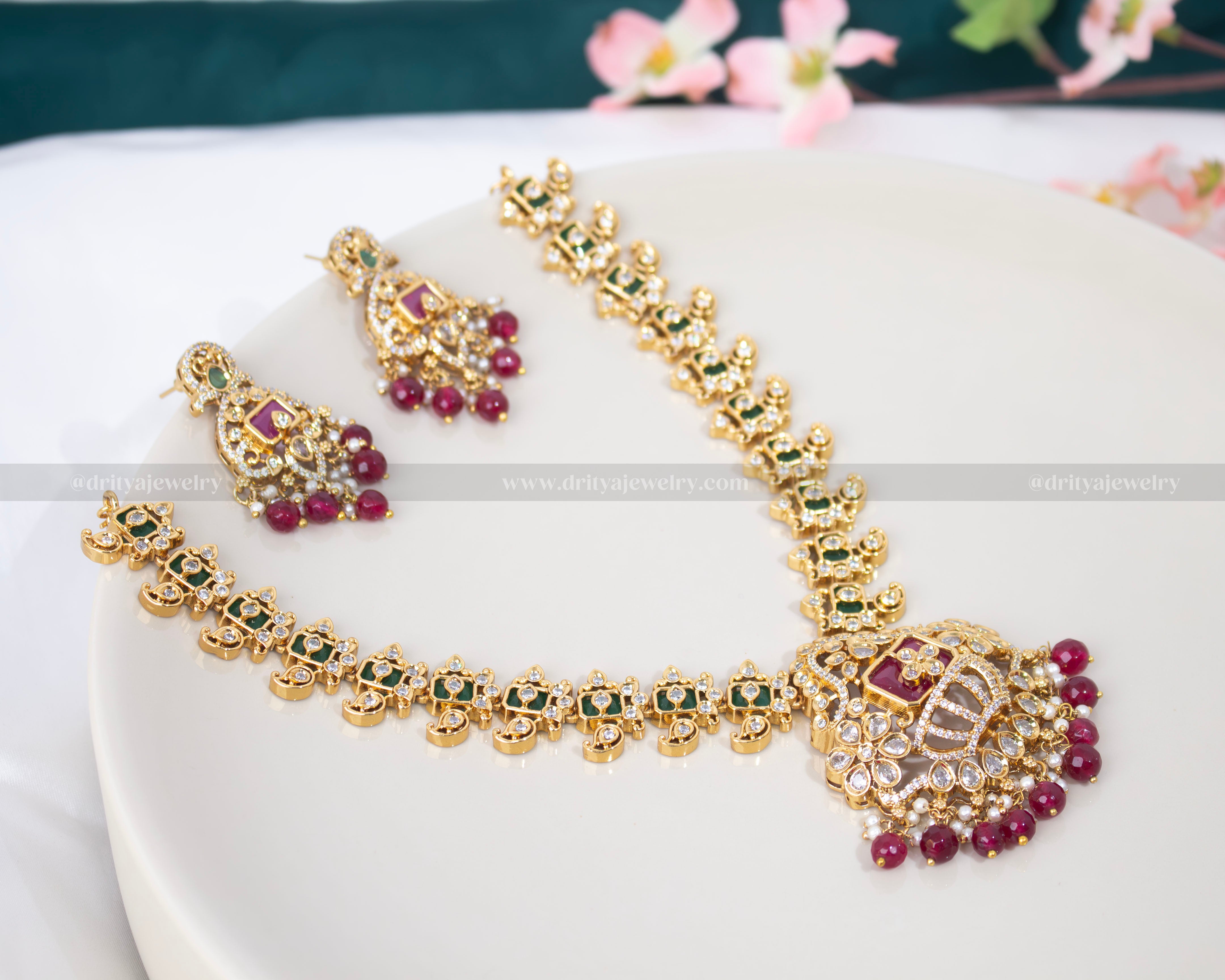 Detailed close-up of the central pendant in the Crown Style Necklace Set by Dritya Jewelry, showcasing layered gem details and ruby bead fringe.