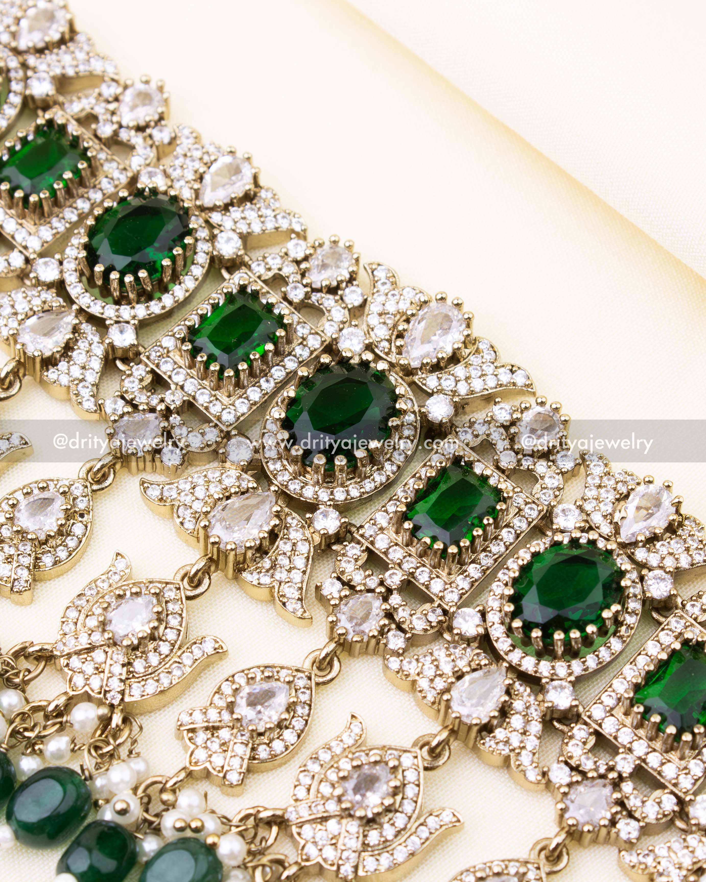 Detailed view of emerald green bridal choker with AD stonework.
