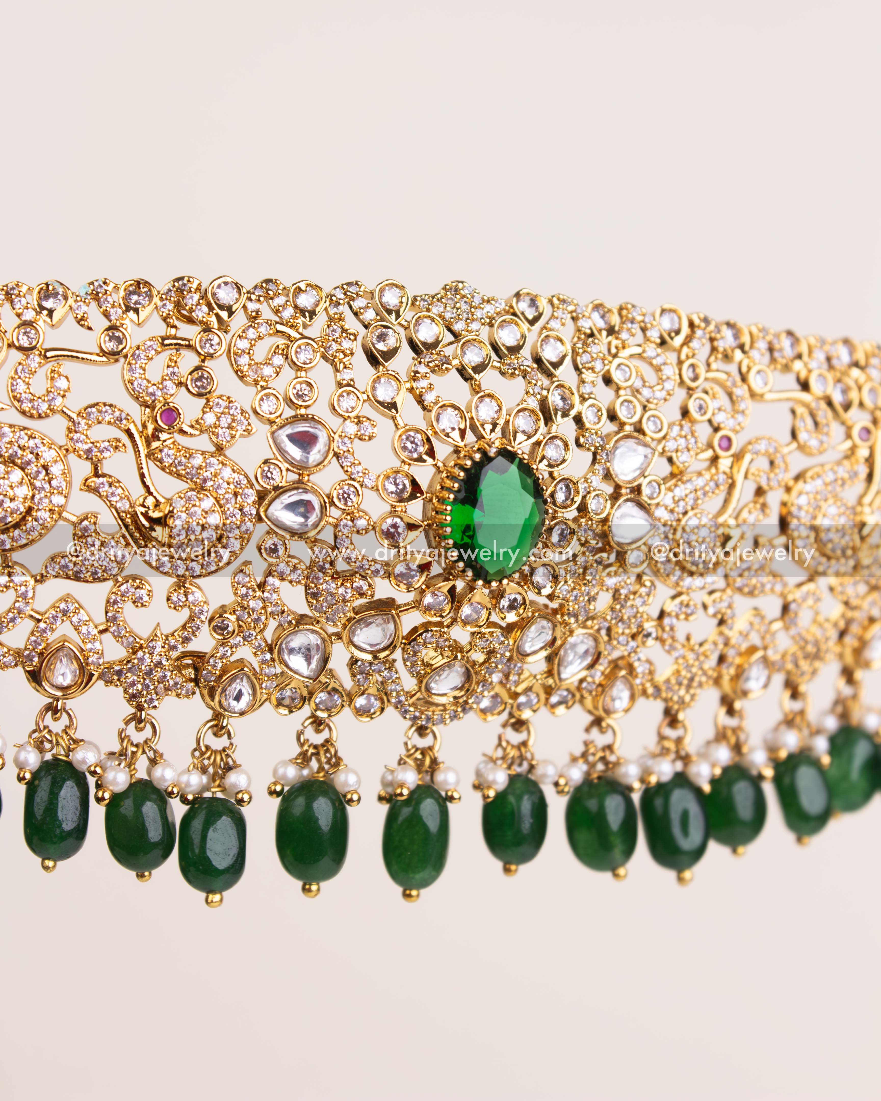 Detailed view of kundan waist belt with green bead hangings and intricate work.