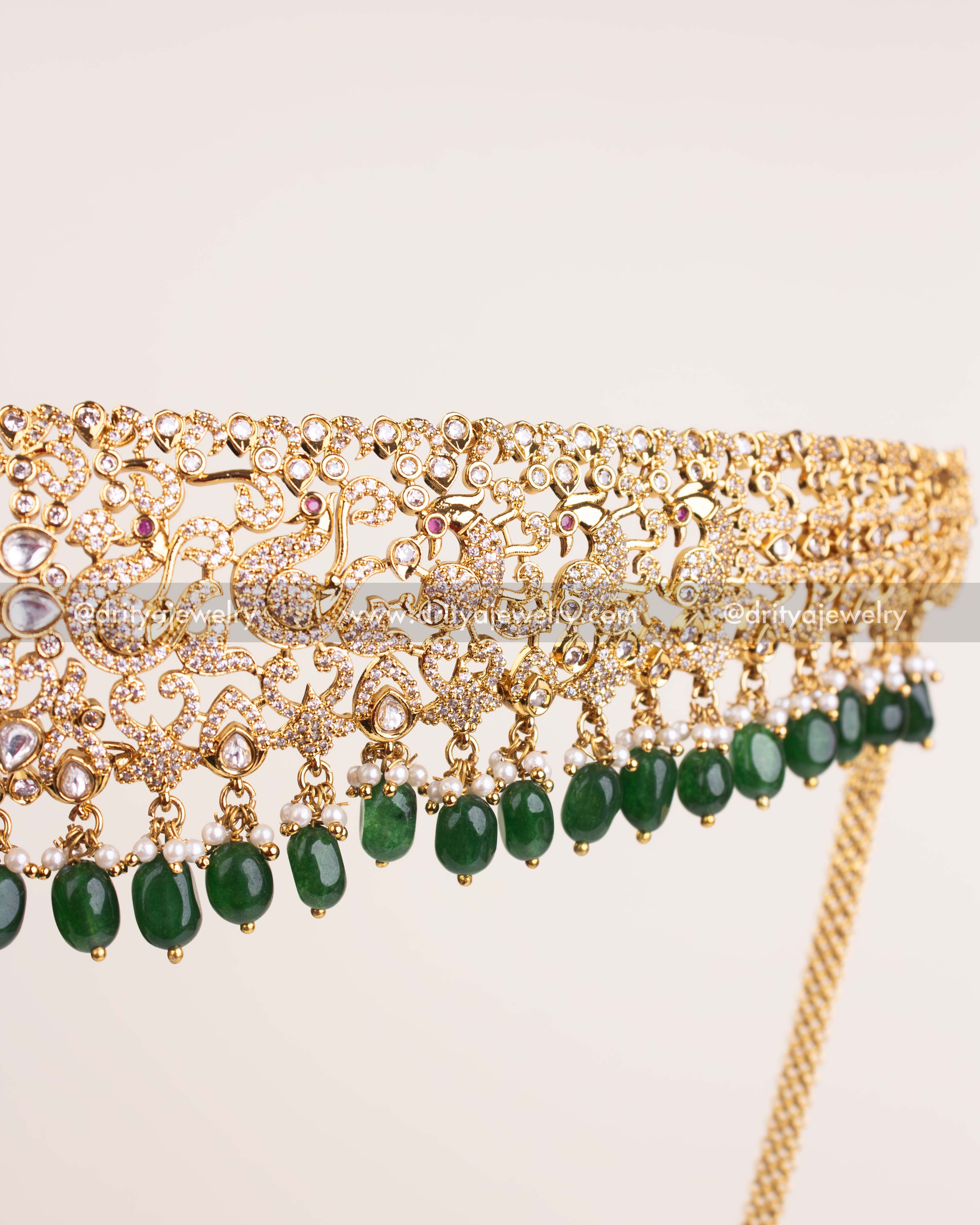 Detailed view of kundan waist belt with green bead hangings and intricate work.
