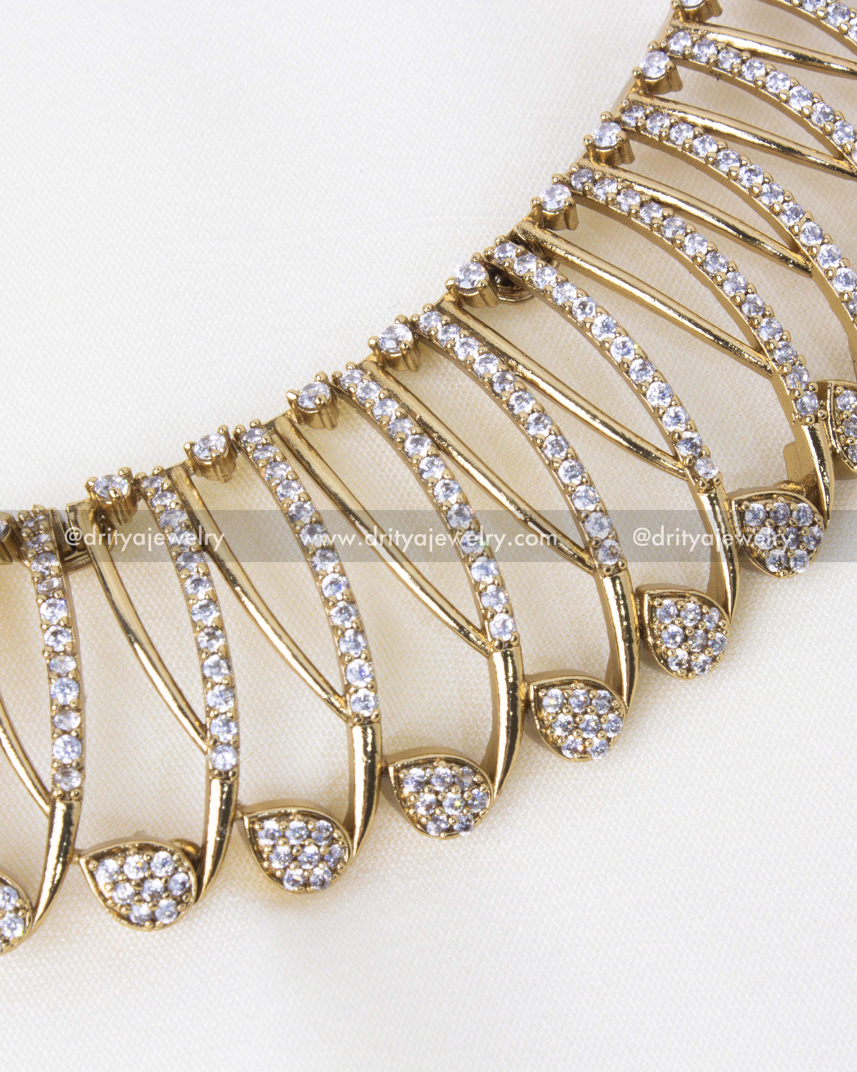 Detailed view of gold-plated floral necklace with intricate stone-studded design.