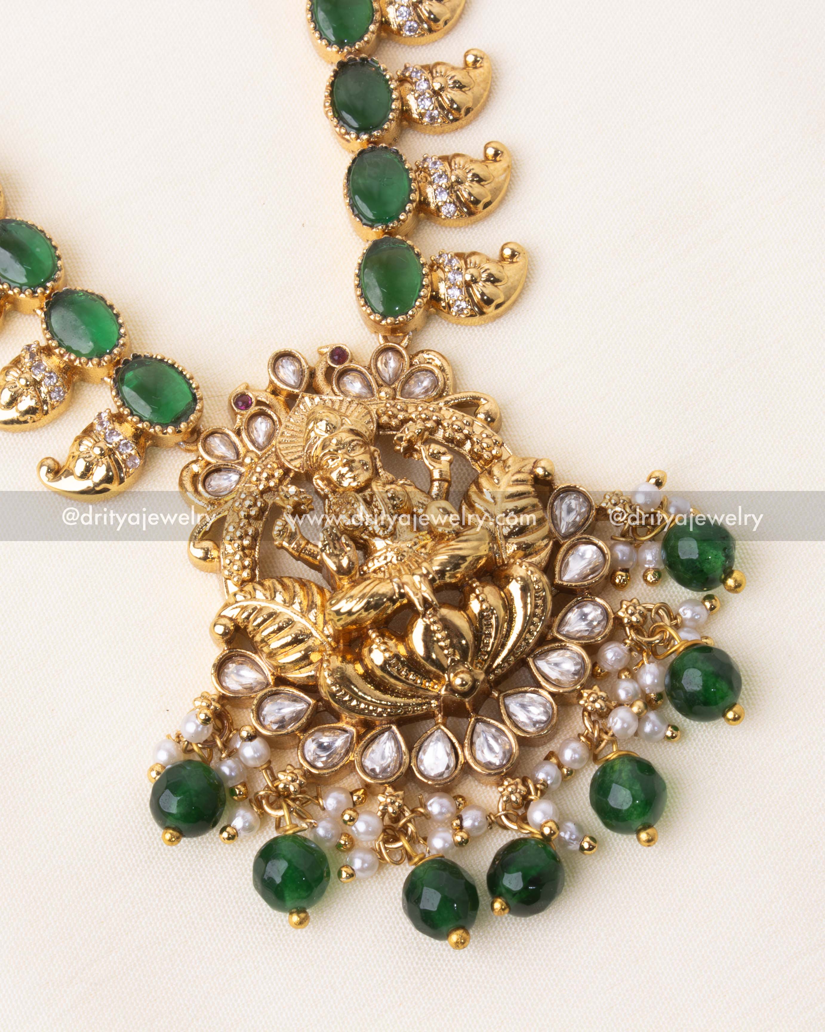 Intricate gold-plated Lakshmi pendant with green accents and pearls.