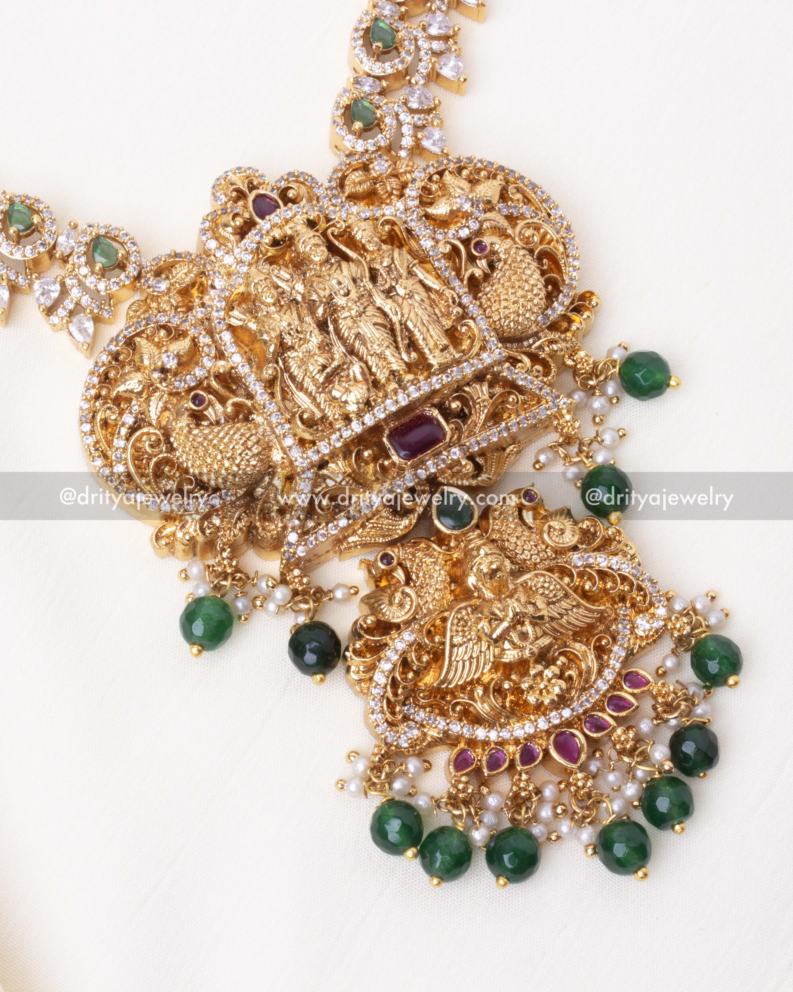 Detailed view of gold-plated Ram Parivar pendant with green stone embellishments and intricate craftsmanship.
