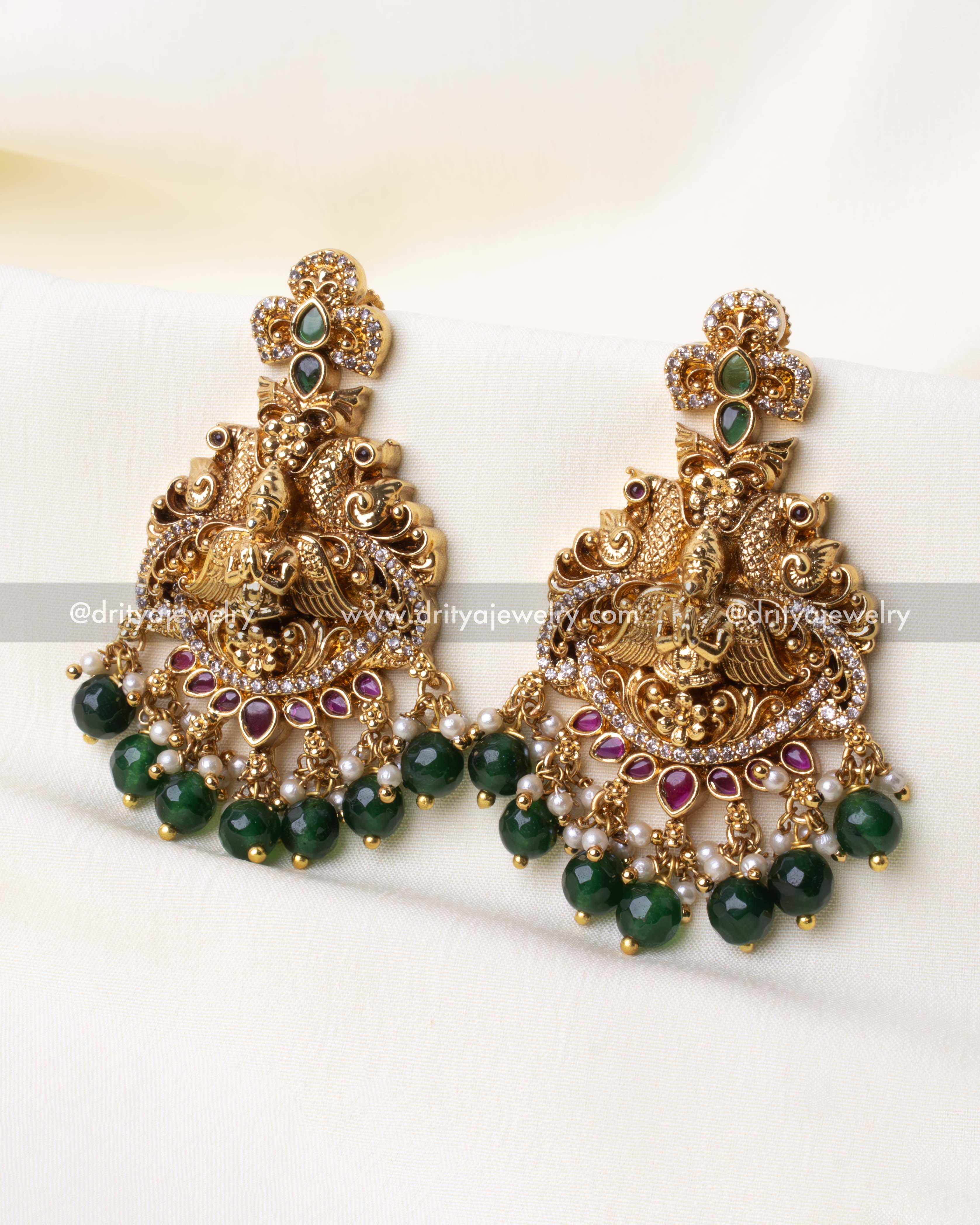 Detailed view of Earrings gold-plated Ram Parivar pendant with green stone embellishments and intricate craftsmanship.