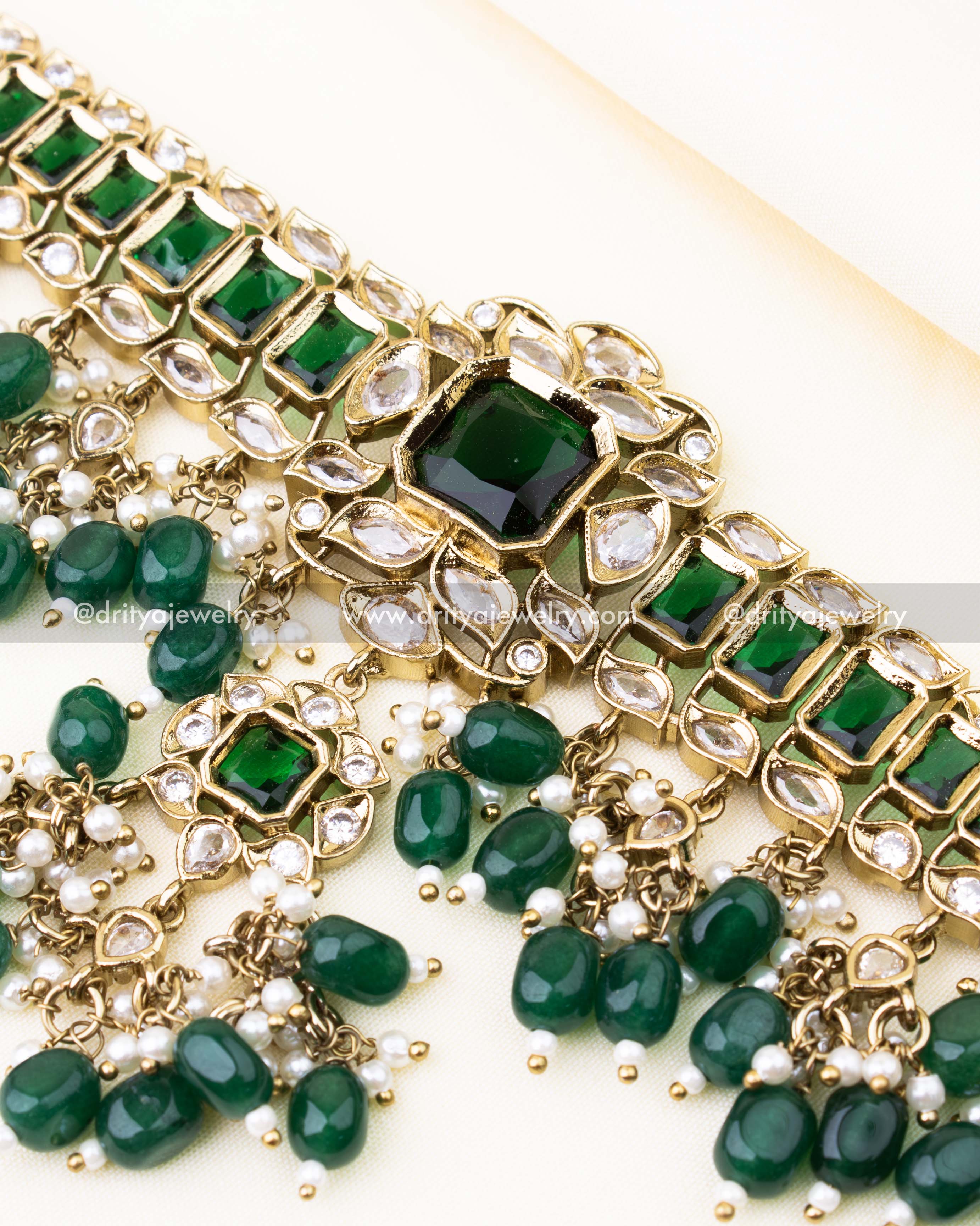 Detailed view of green choker necklace with reverse AD stones and bead clusters in antique finish.