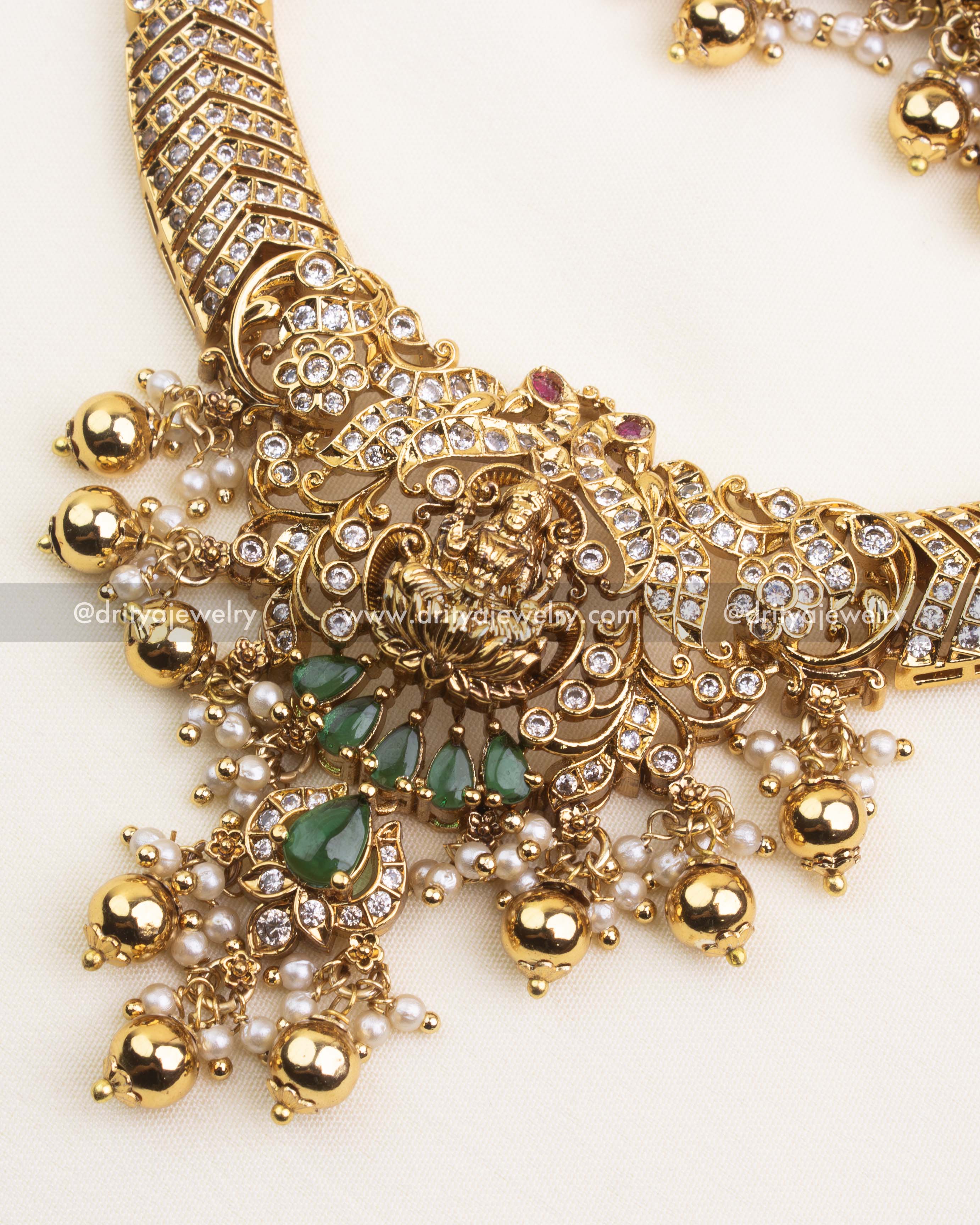 Detailed pendant view with Goddess Lakshmi motif, CZ embellishments, and green stones.