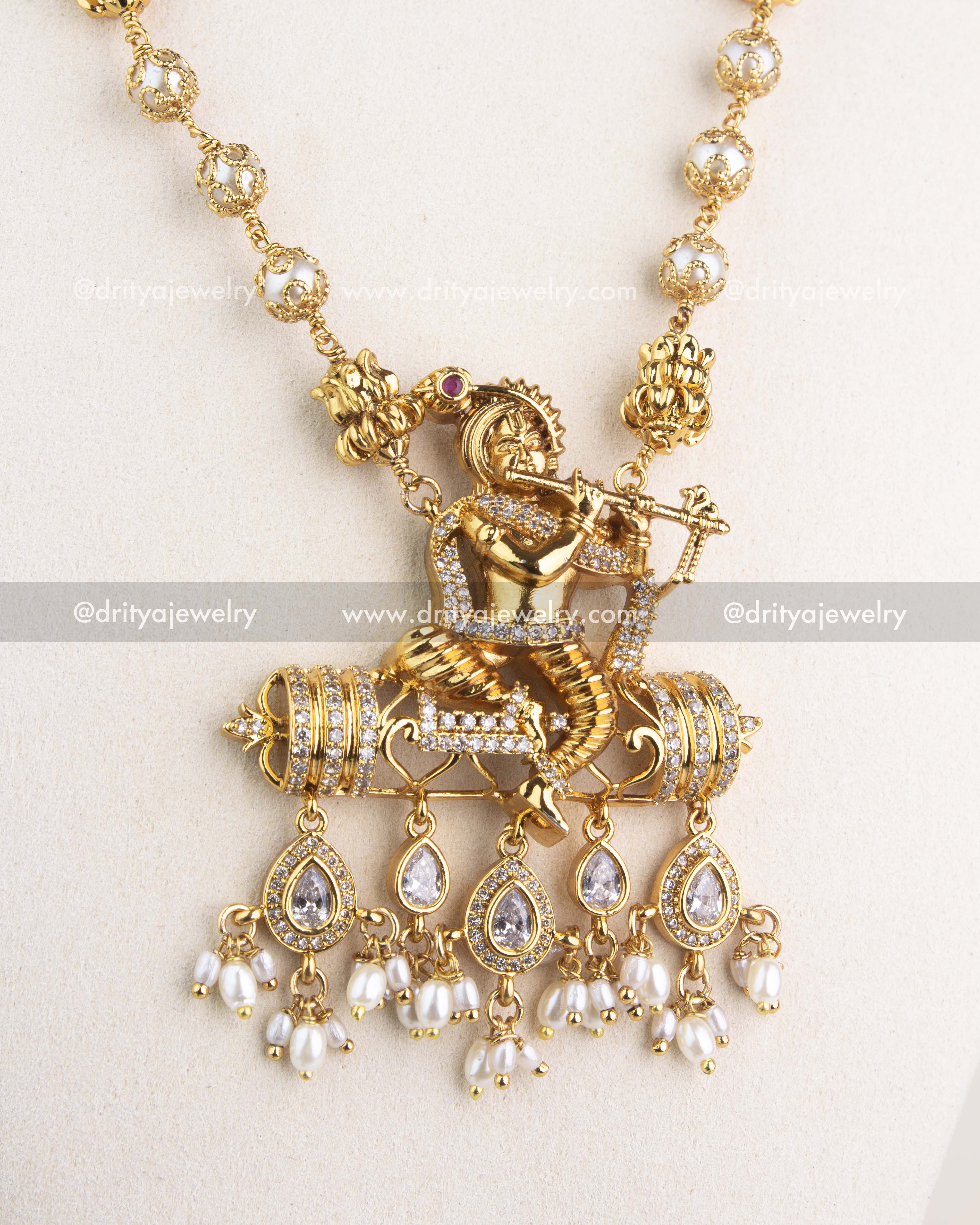 Intricate Krishna pendant design with CZ stones and dangling pearl drops.