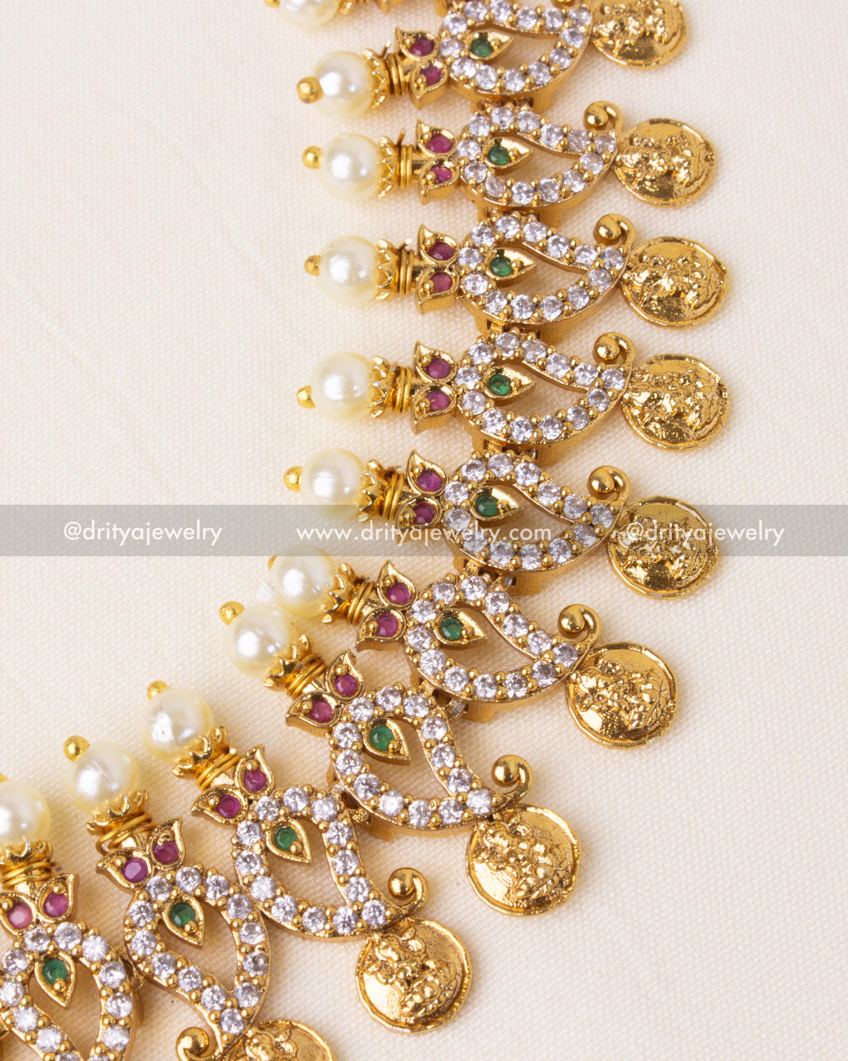 Exquisite mango-shaped motifs with shimmering CZ stones, pearls, and ruby-emerald accents.