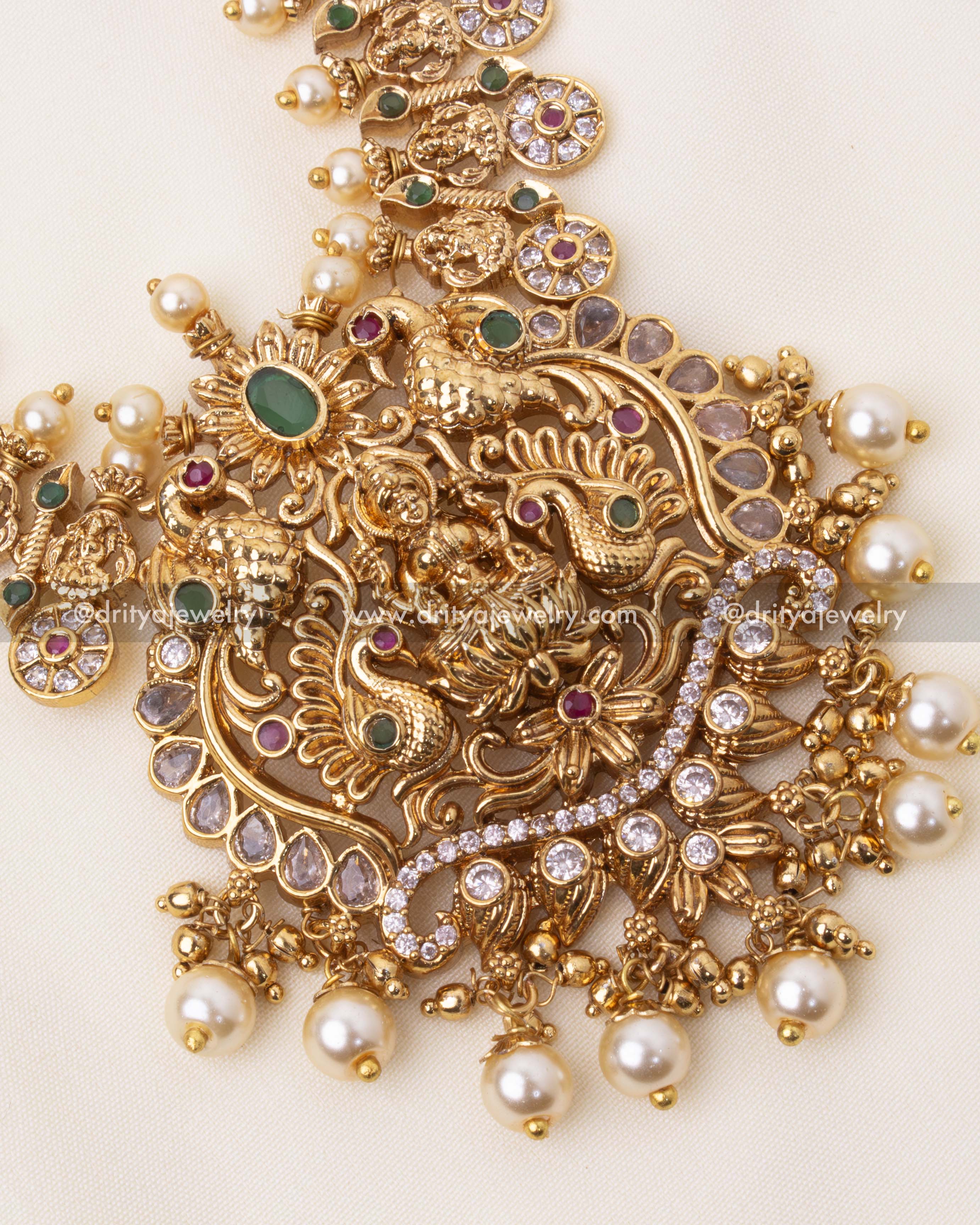 Intricate pendant with goddess Lakshmi motif, peacock designs, and pearl embellishments.