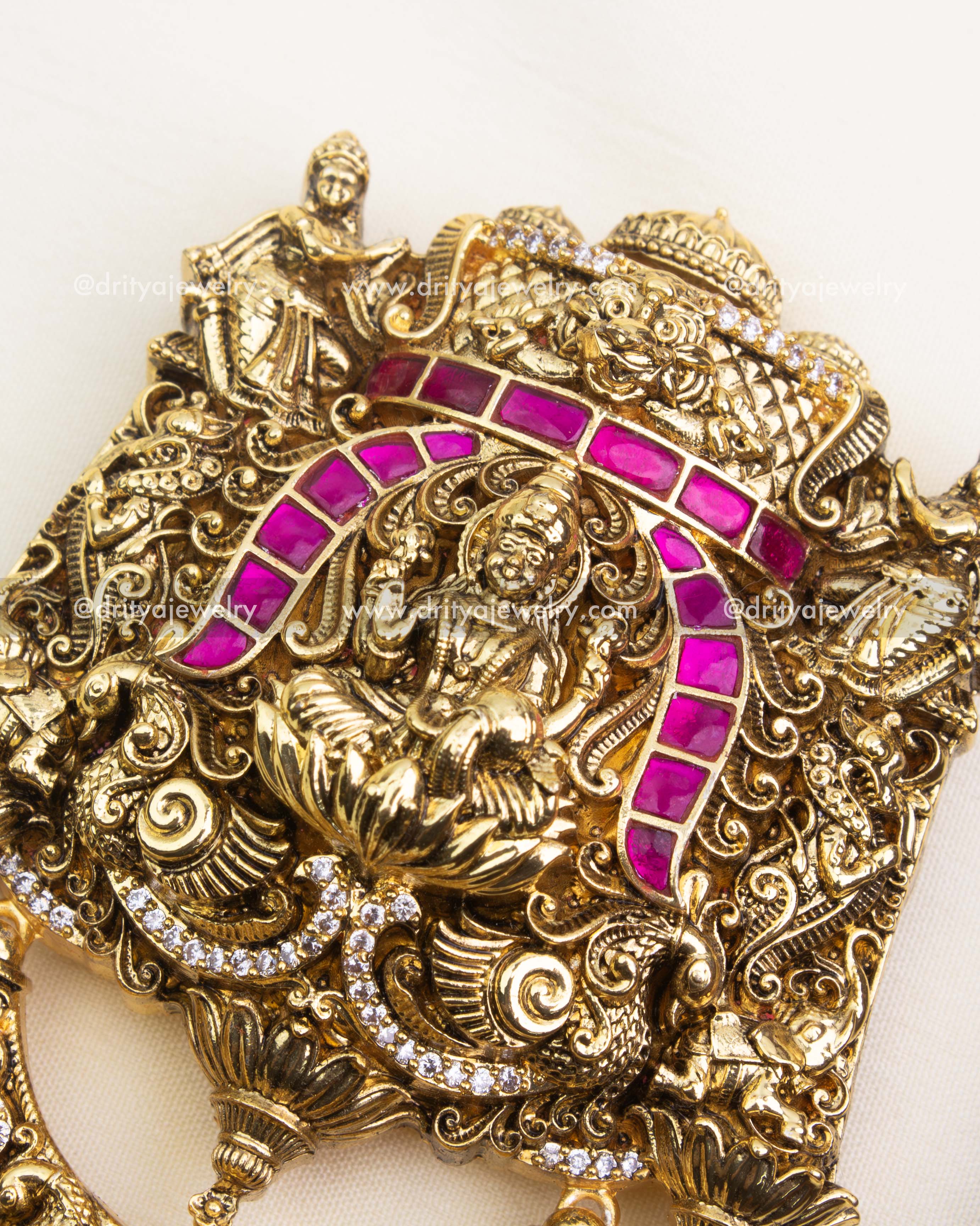 Intricate Nakshi detailing with pink stones on antique polished Jada Billa.