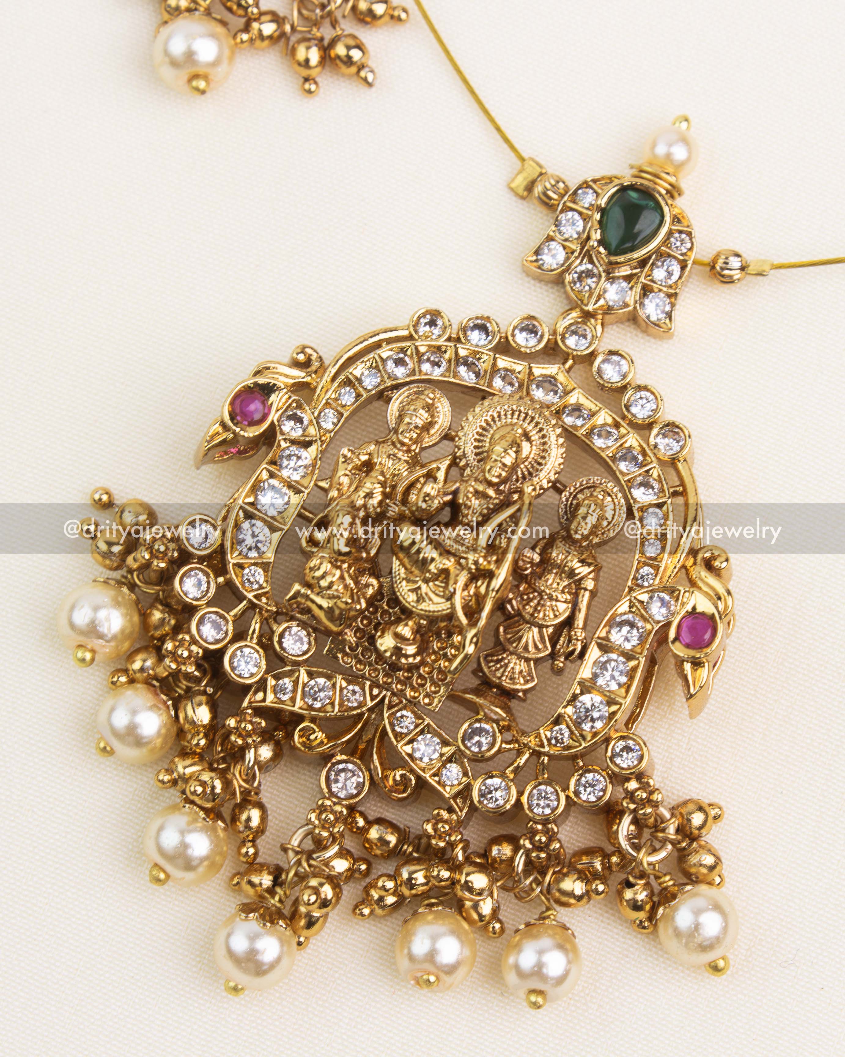 Detailed depiction of Ram Parivar with CZ accents and antique gold finish pendant design.