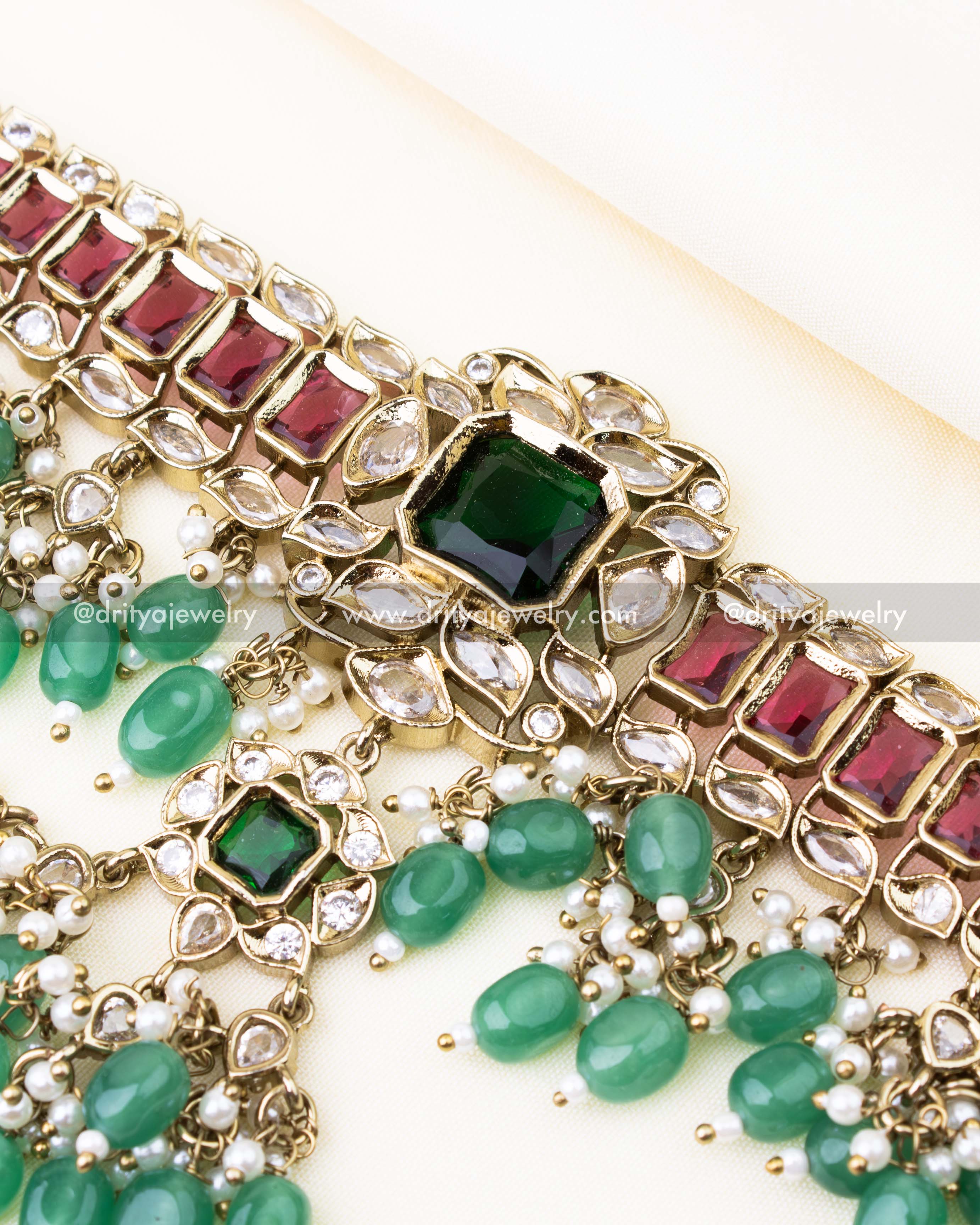 Detailed view of choker with red-green stones, reverse AD settings, and green bead clusters.