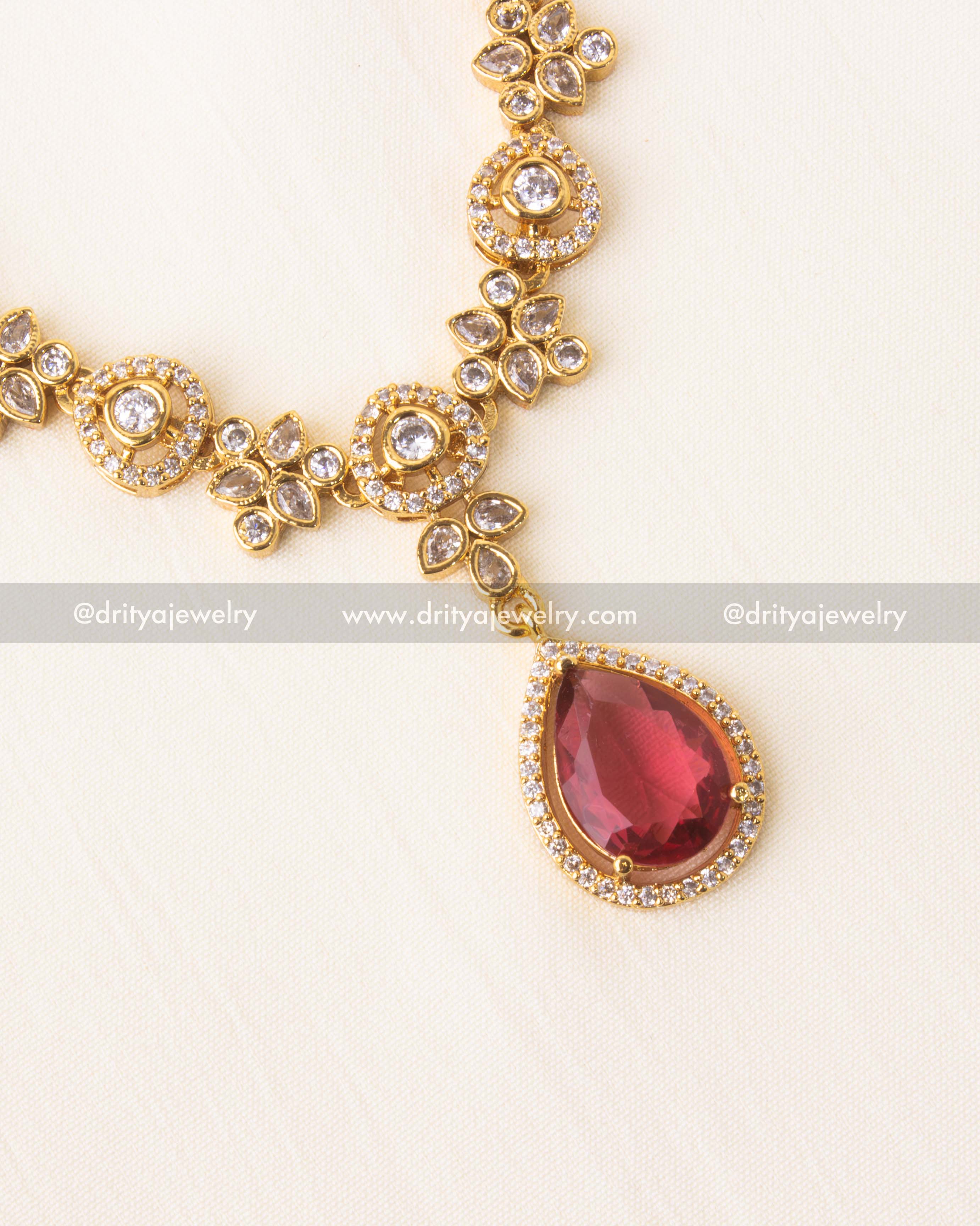 Red gemstone pendant with CZ border on floral short necklace.