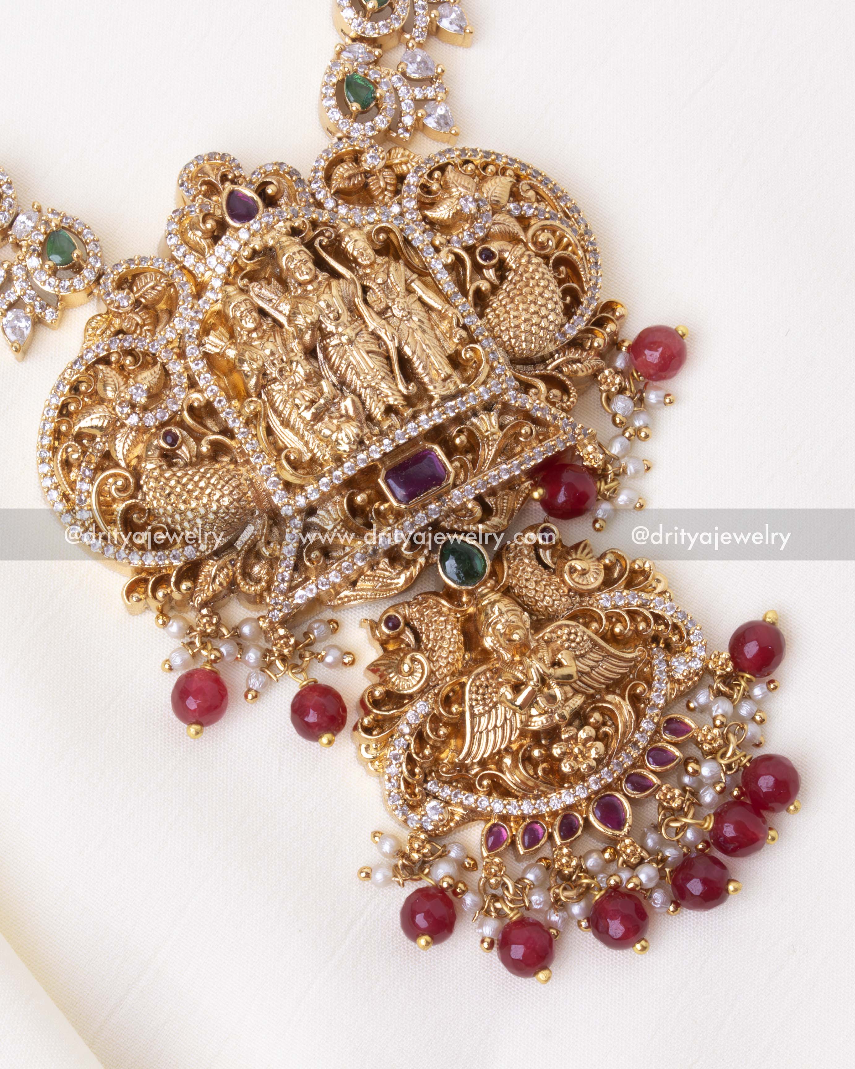 Detailed view of gold-plated Ram Parivar pendant with red stone embellishments and intricate craftsmanship.