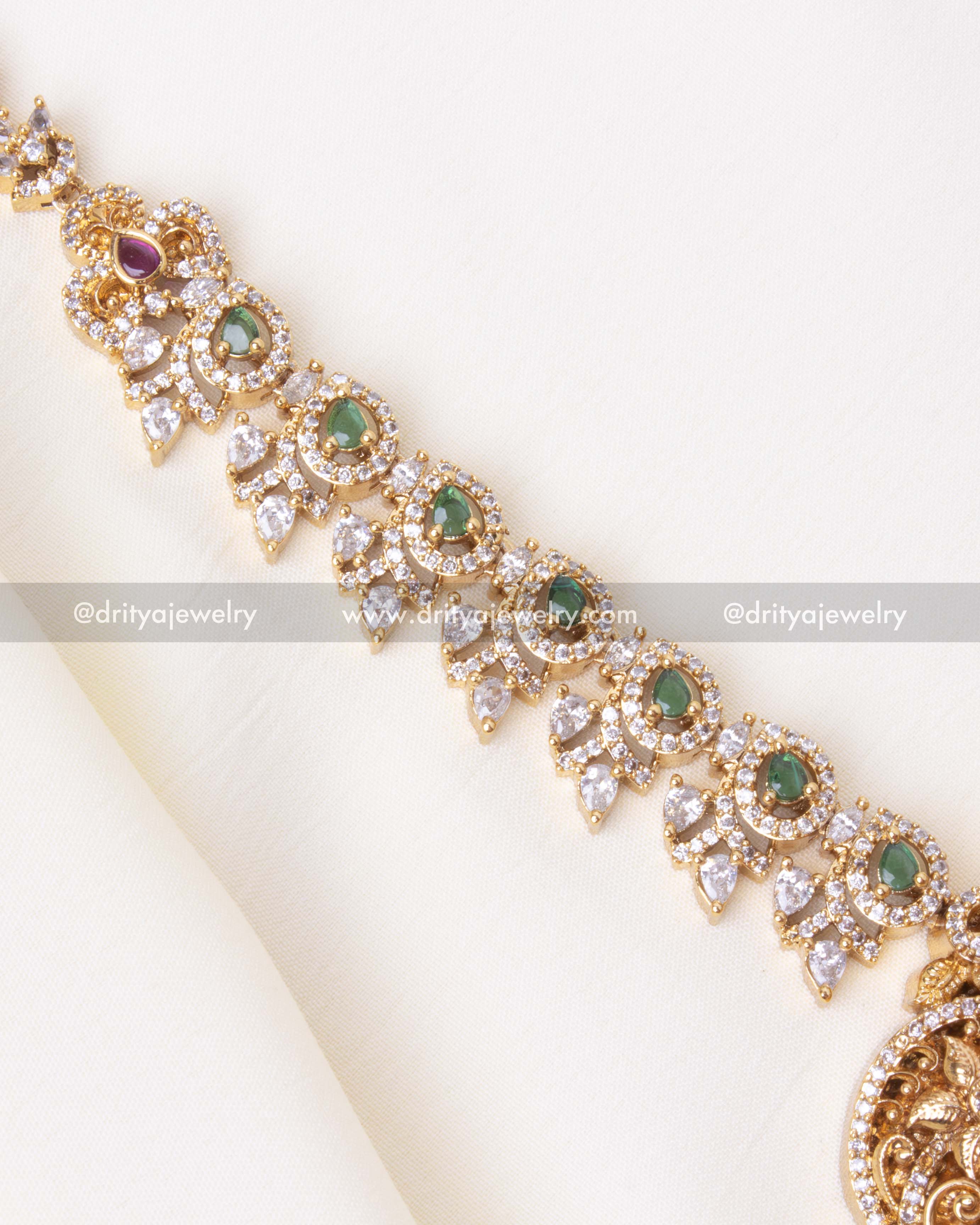 Detailed view of gold-plated Ram Parivar pendant with red stone embellishments and intricate craftsmanship.