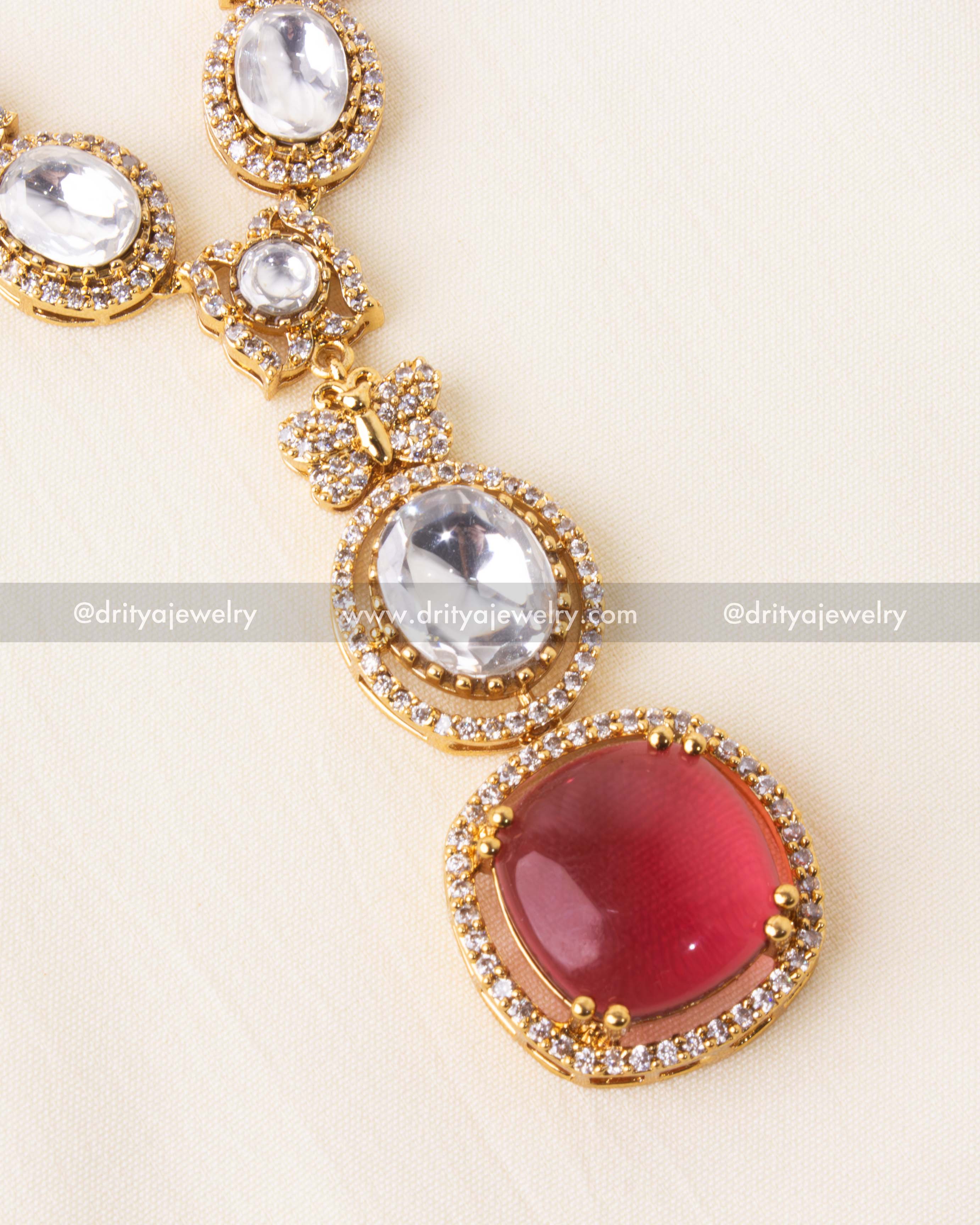 Detailed close-up of ruby red pendant with CZ-studded border.