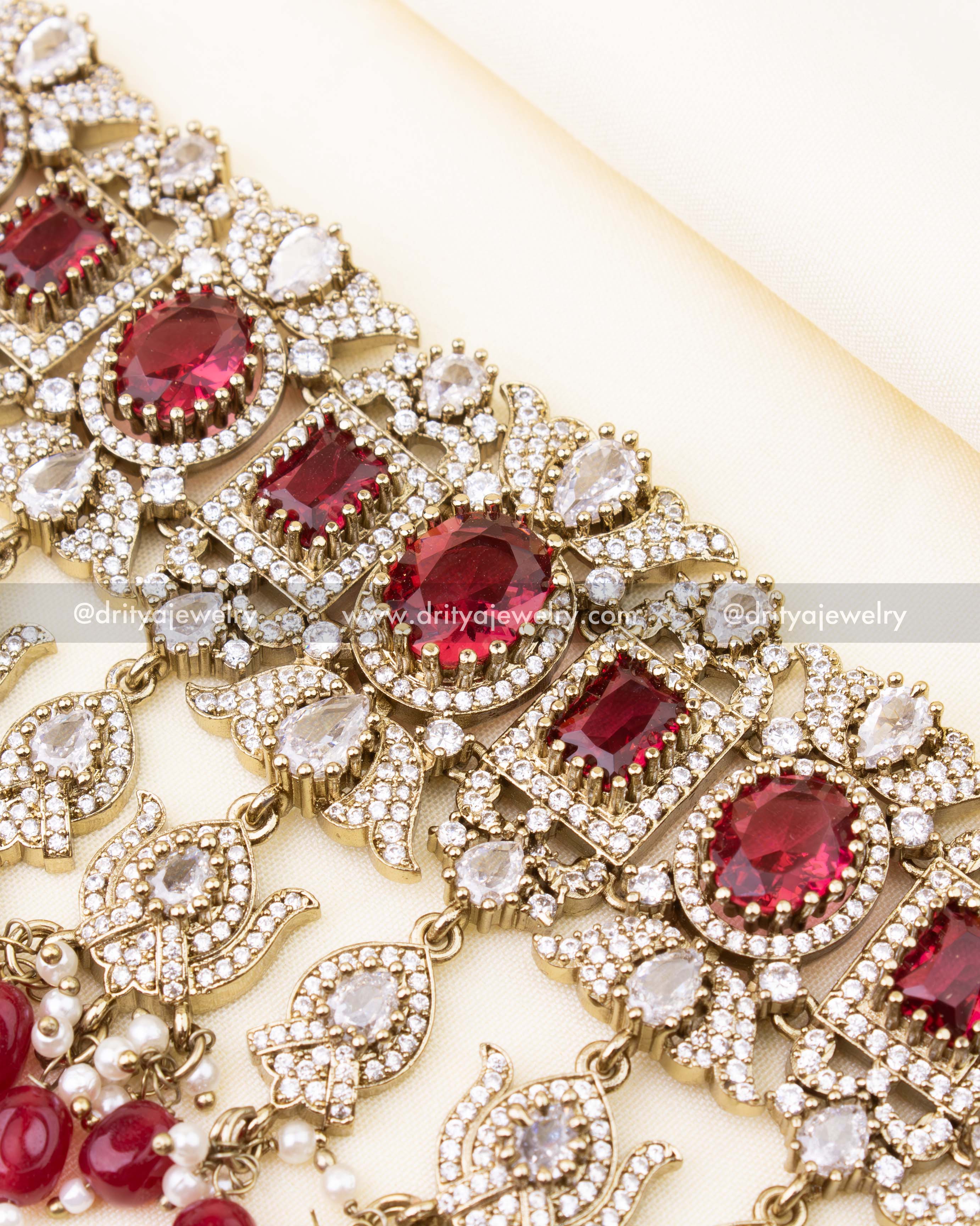 Detailed design of ruby red bridal choker with sparkling stonework.