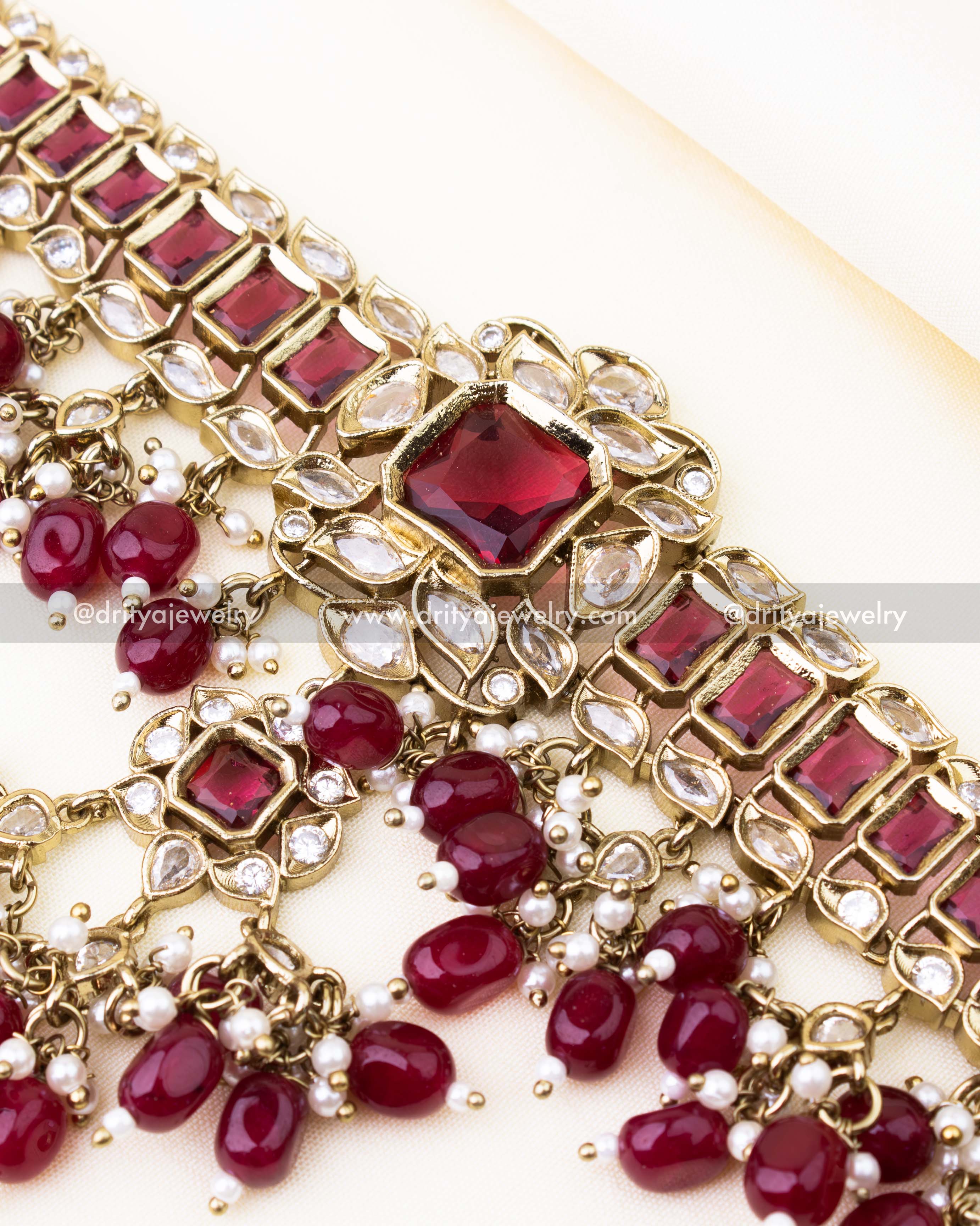 Detailed view of red choker with reverse AD stones and vibrant red bead clusters.