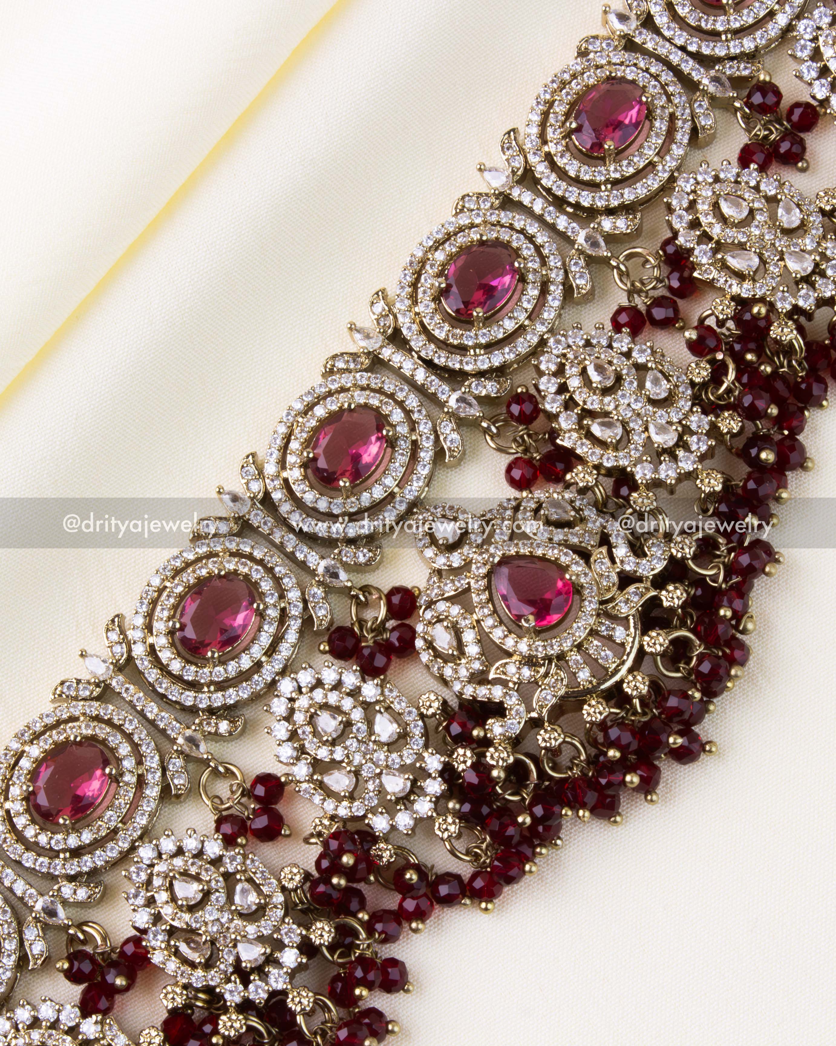 Detailed close-up showcasing ruby stones and layered red bead drops.