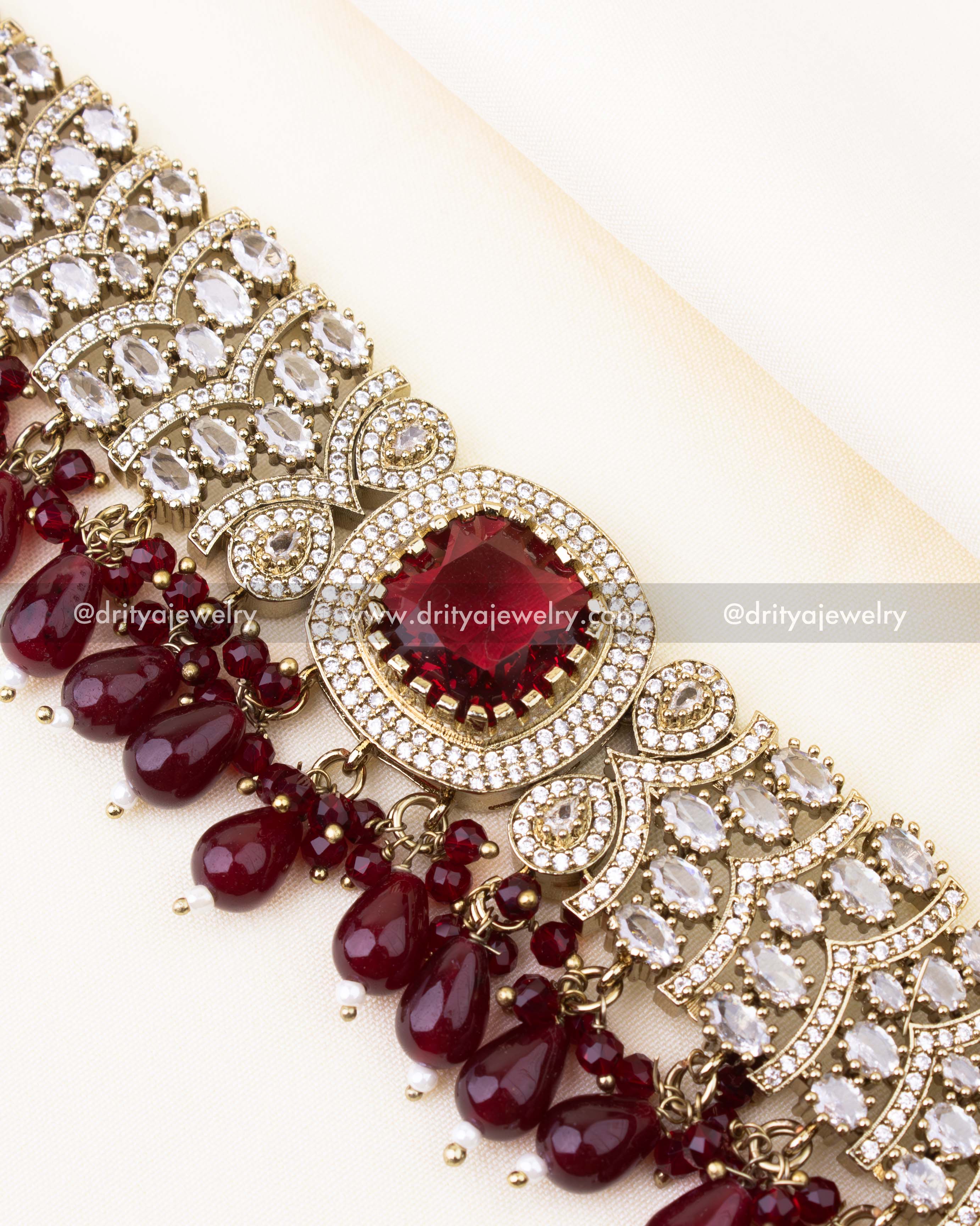 Detailed view of ruby red Victorian choker with AD stones.