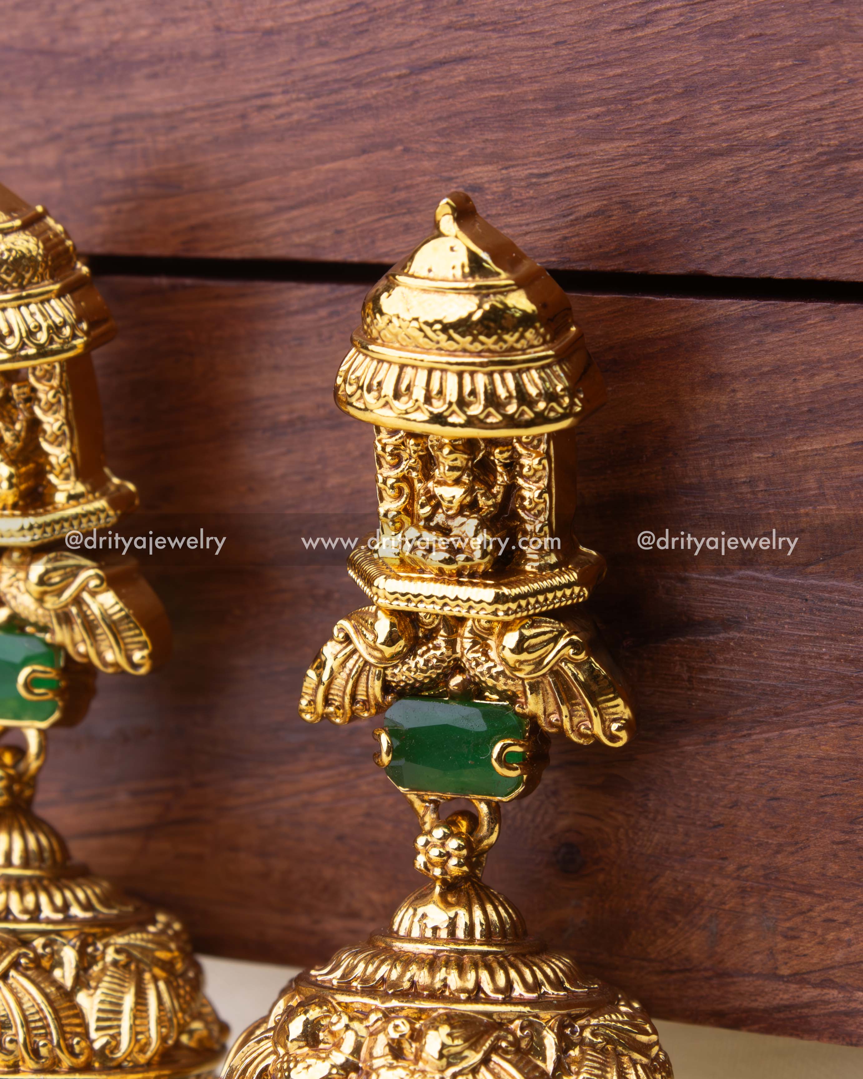 Detailed temple-style stud with Goddess Lakshmi motif and green stone connector.