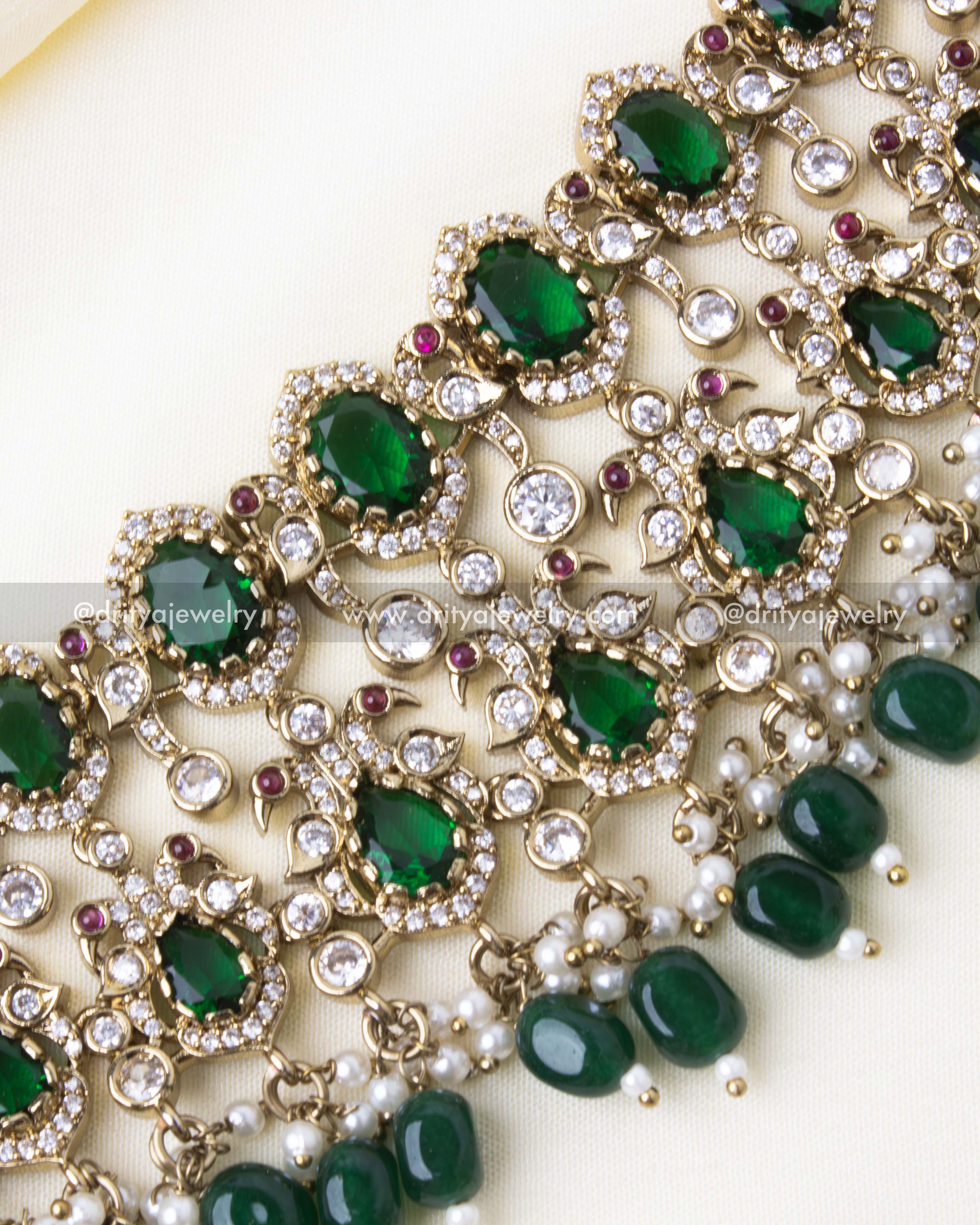 Close-up view of premium Victorian choker with green gemstones, cubic zirconia, and pearl tassels.