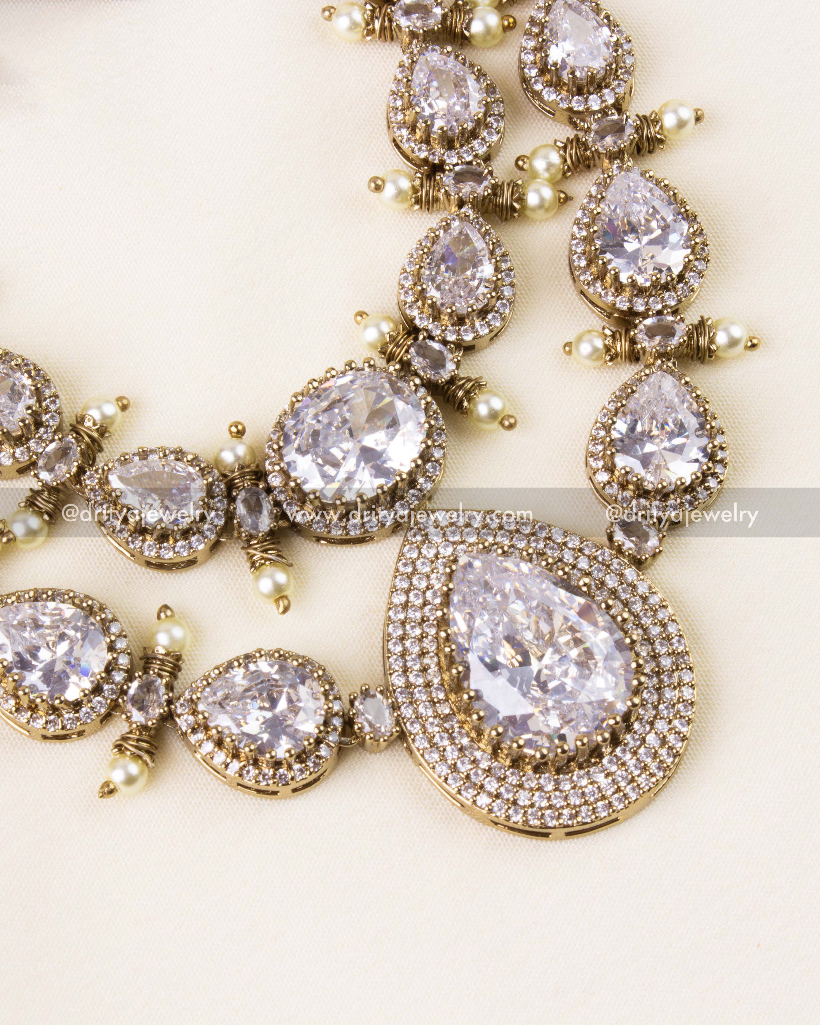Zoomed-in view of gold-plated Victorian necklace with brilliant-cut CZ stones and pearl accents.