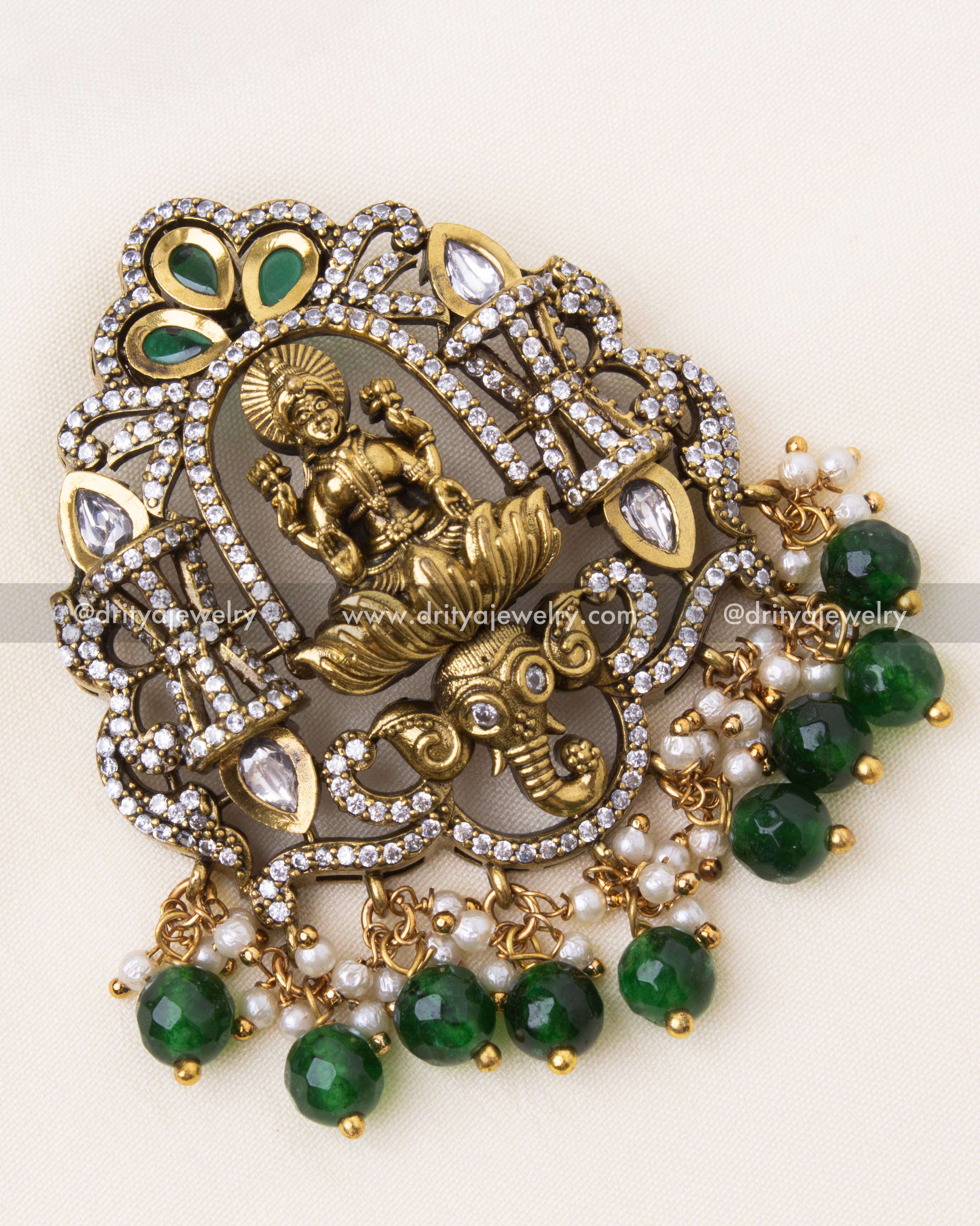 Detailed close-up of a Victorian-style pendant with polki stones, pearl clusters, and intricate deity carving.
