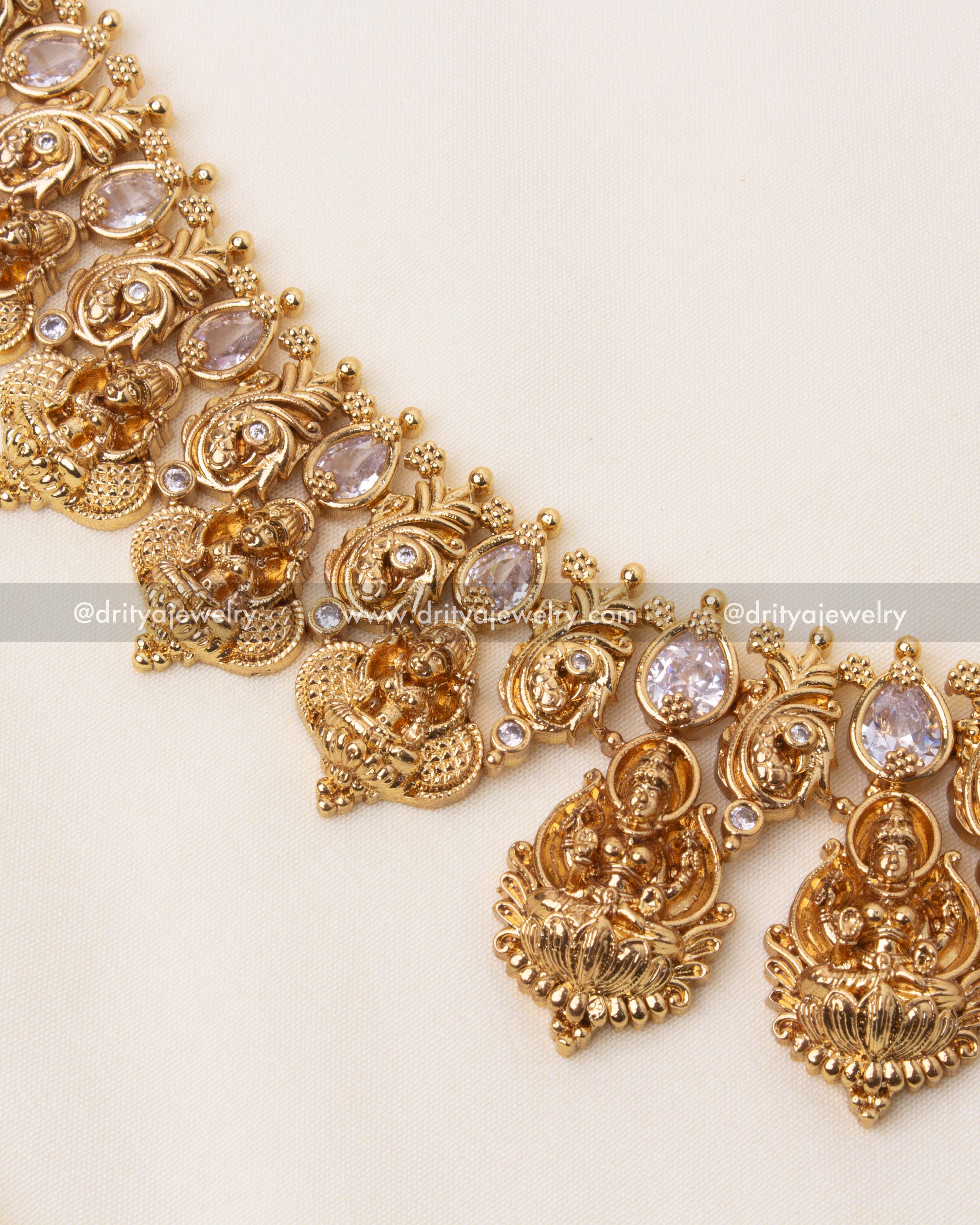 Intricate detailing of the long haram featuring Lakshmi motifs and shimmering white stones.