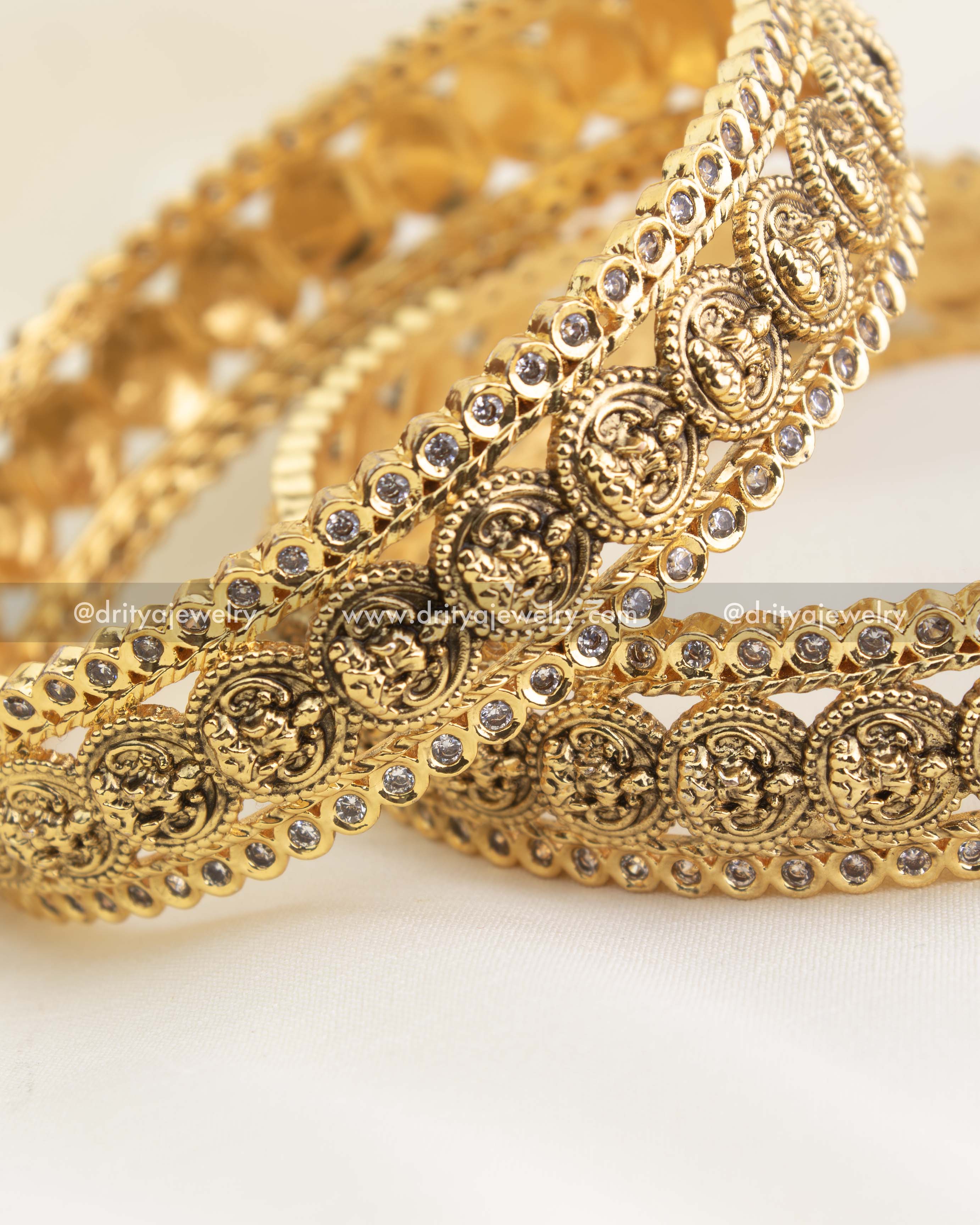 Macro shot showing embossed Lakshmi kasu discs, rope edges, and micro-pavé CZ border.