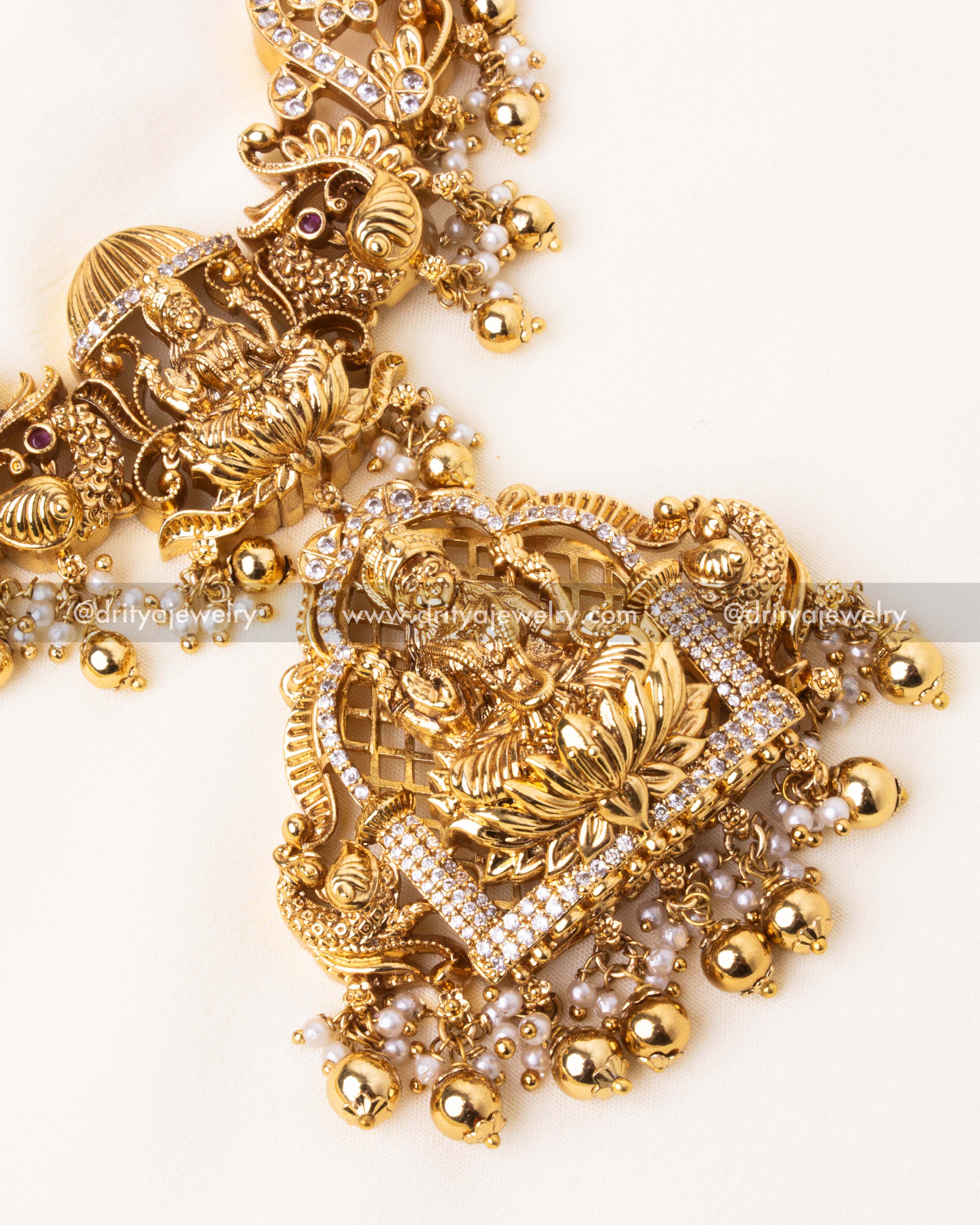 Exquisite deity motif pendant with peacock detailing and pearl embellishments in an antique gold finish.
