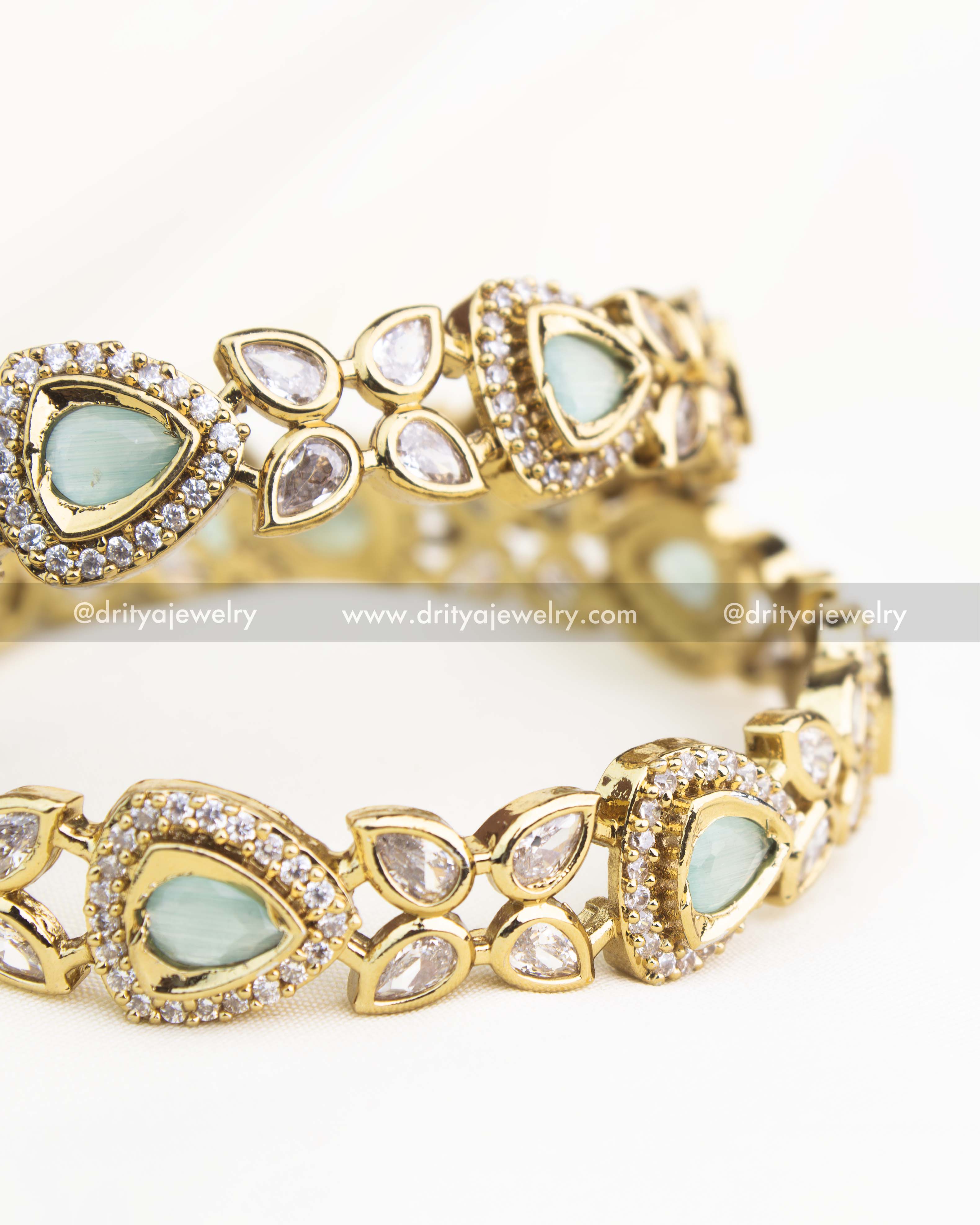Detailed shot highlighting mint green stones and shimmering AD accents in gold-plated Victorian bangles.