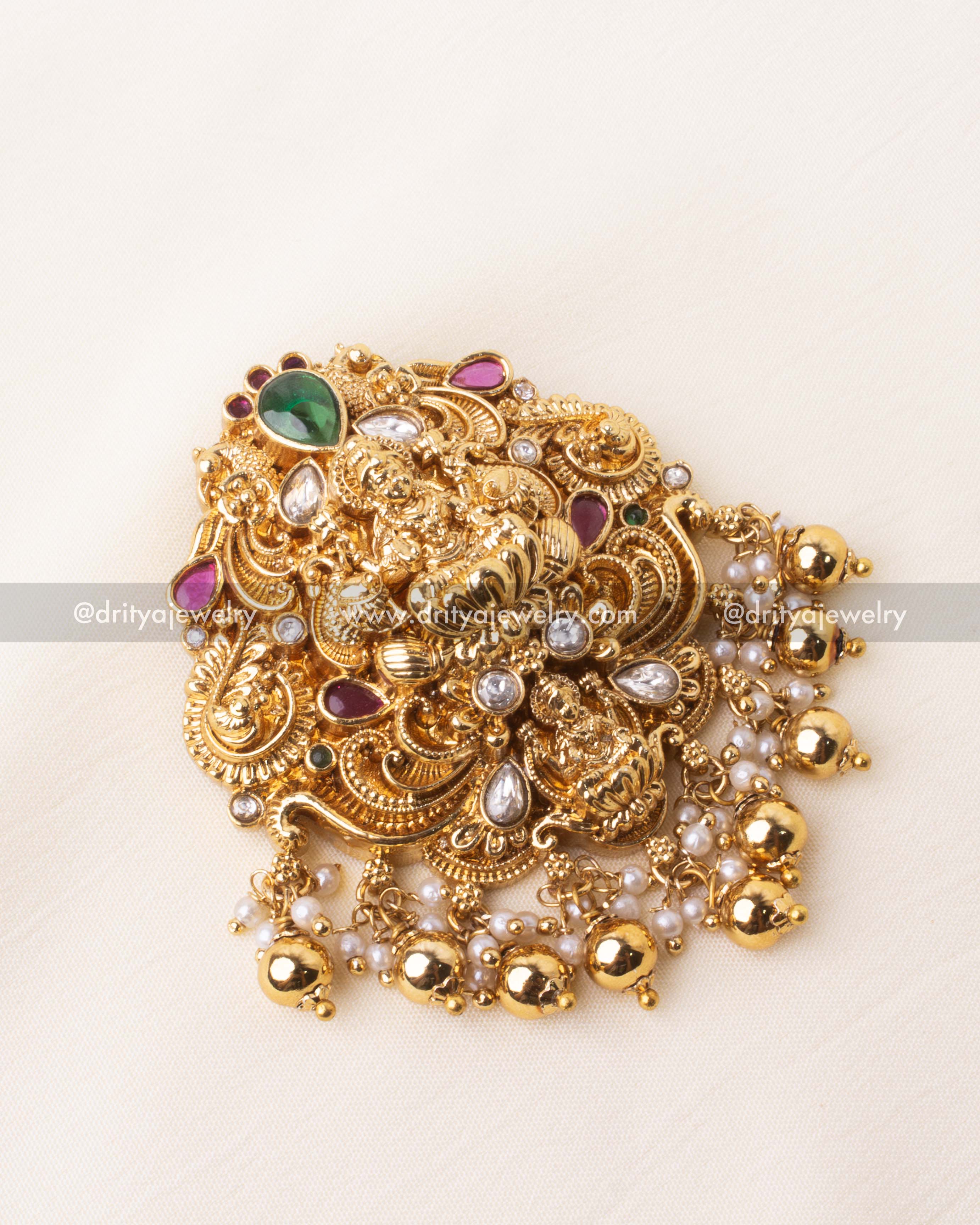 Detailed view of Lakshmi motif pendant with kundan stones and ghungroo beads